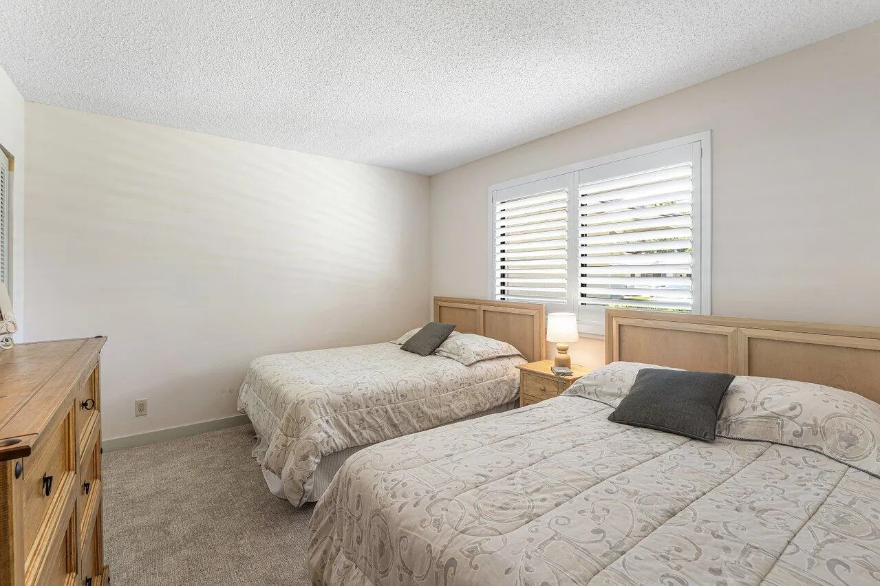 Guest bedroom features two full sized beds.