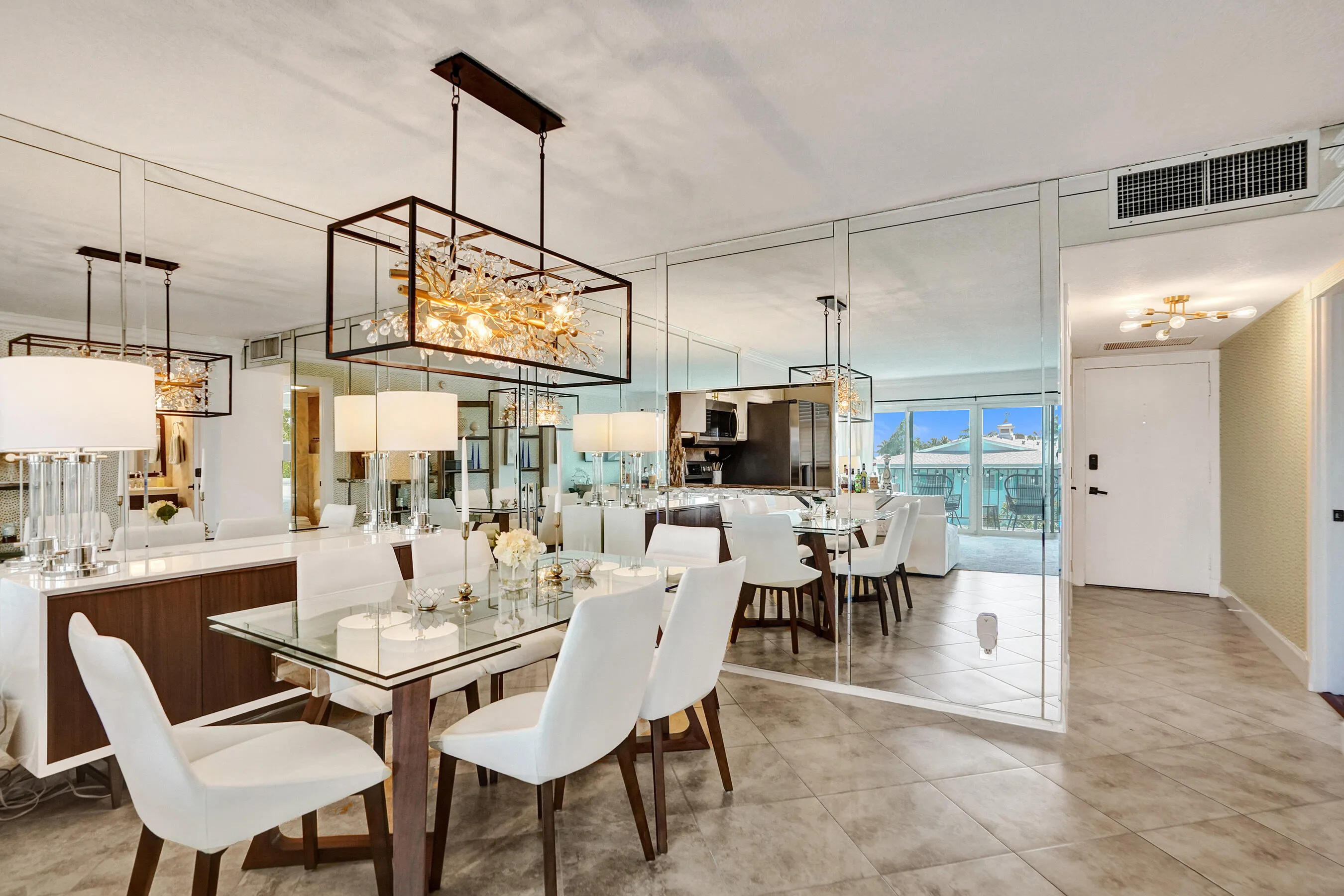Dining room has mirrored walls for more opportunities of view.