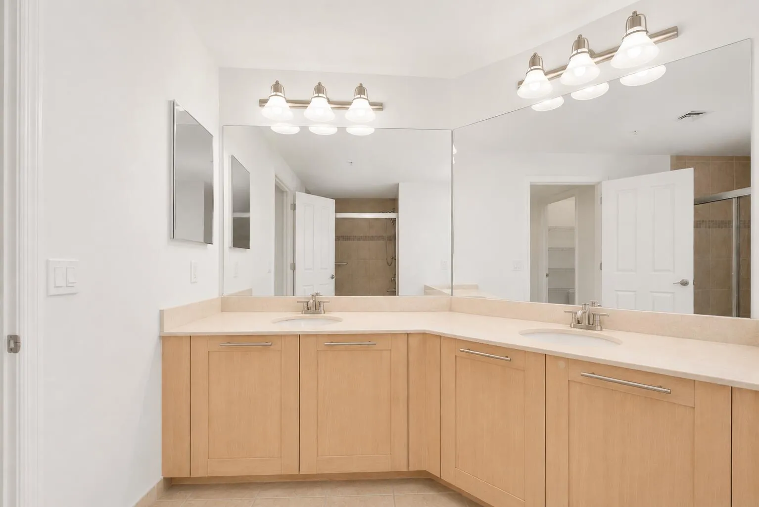 Primary Bathroom with double vanity sinks, tub/shower combo & shower glass door