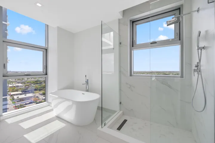 primary suite full bathroom with walk-in shower and tub