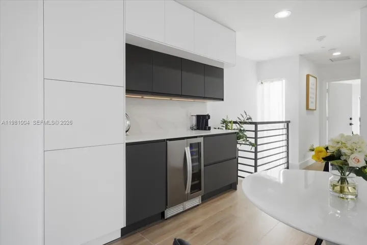 built out bar with wine cooler on 3rd level