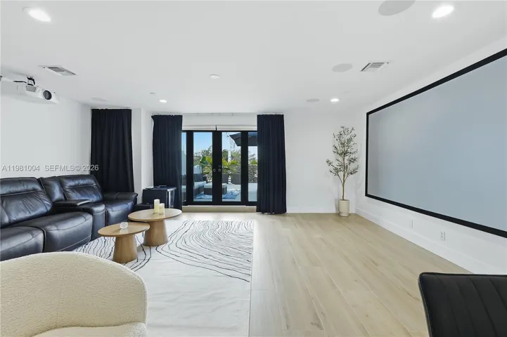 entertainment/media room with surround sound speakers and large projector screen
