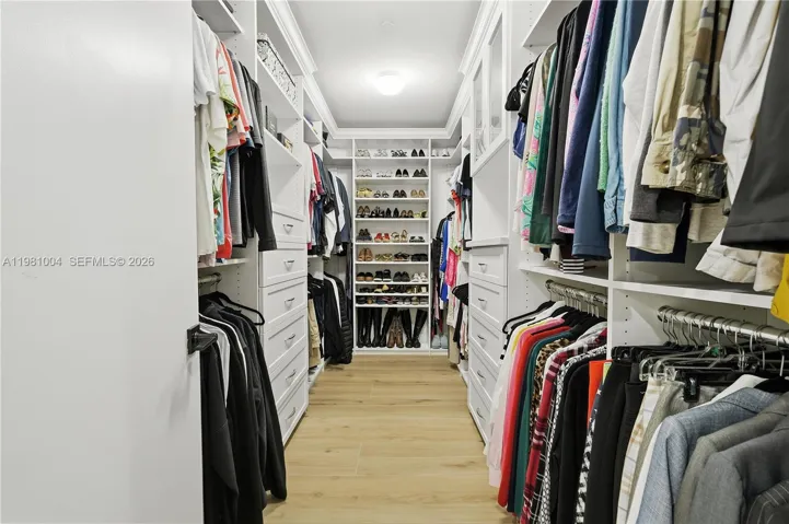 walk in closet primary suite - there are also 2 smaller closets in the primary