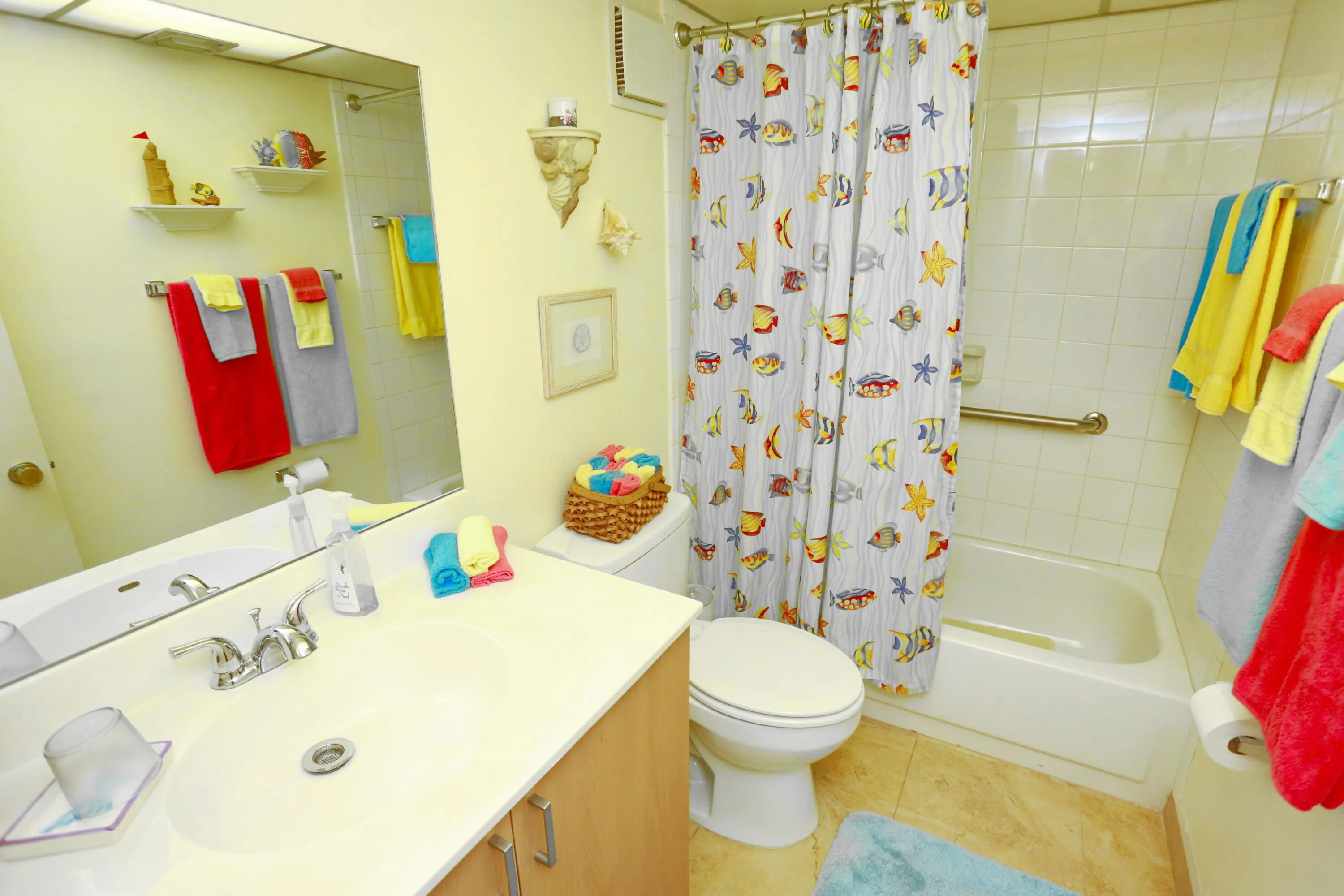 guest bathroom with grab bar in tub/shower