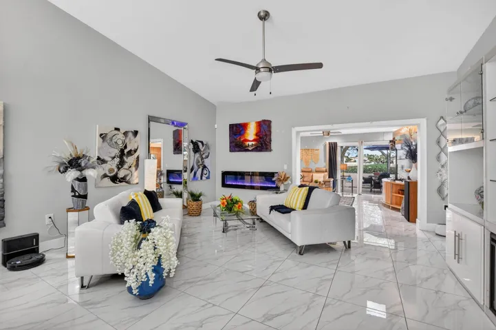 WOW, gorgeous porcelain tile! Living room with soaring 12' ceiling provides tons of natural light!