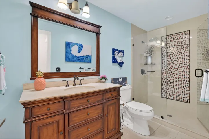 Guest bath has a counter-height vanity with marble top.