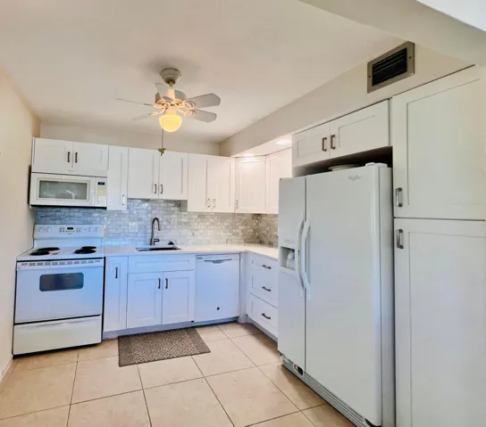 WOW! Updated 2/2 Corner Penthouse With Water Views in the Luxury Wellington Section of Century Village!