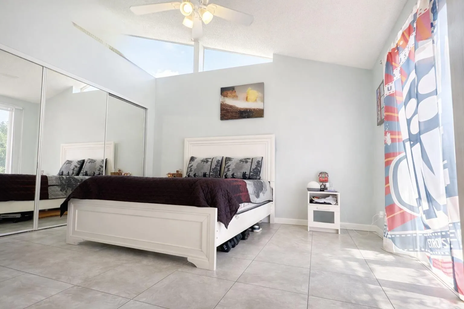 Bright and airy bedroom with mirrors