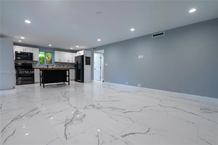 Bright open kitchen, dining, and living area perfect for entertaining.