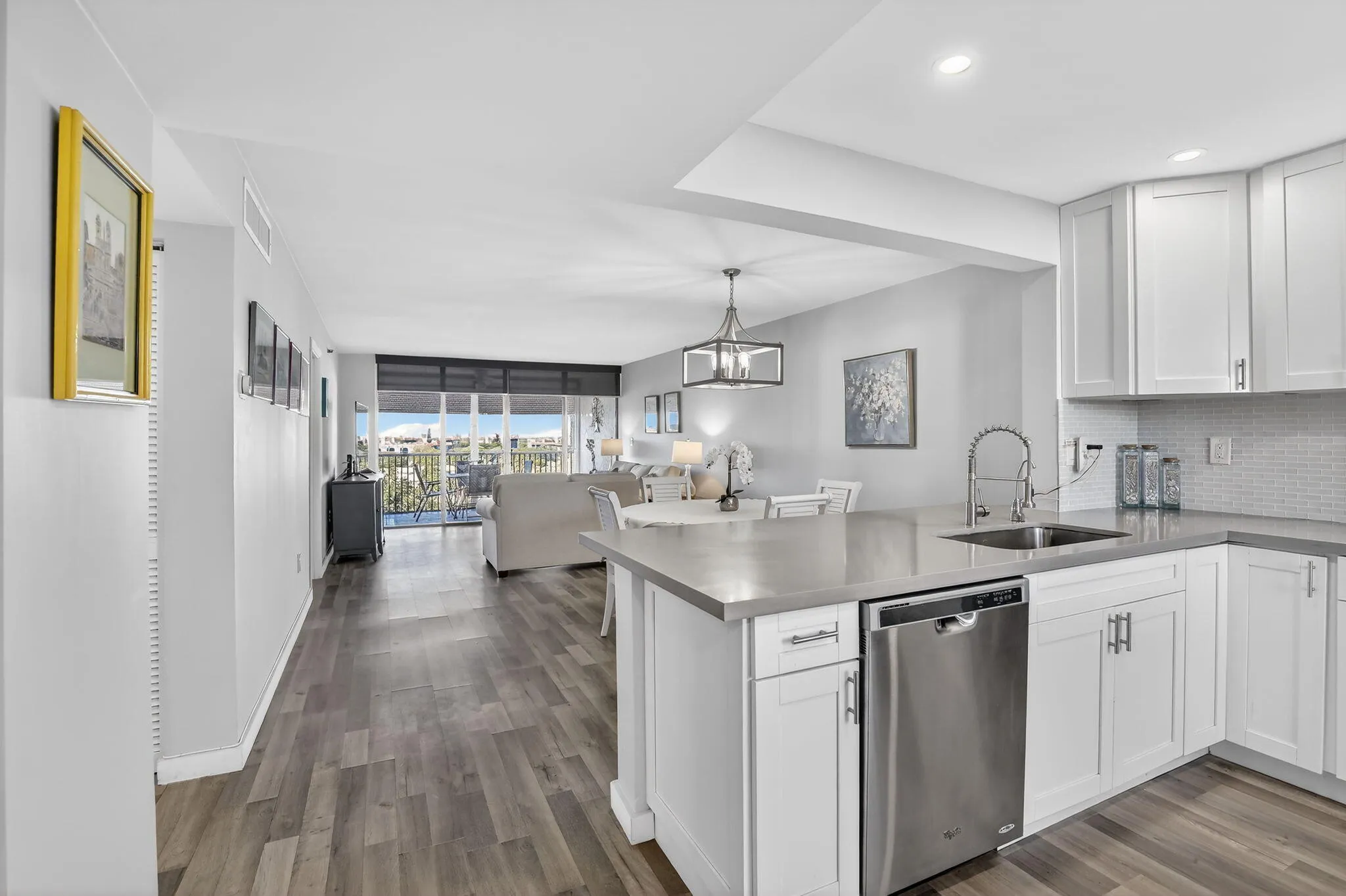 Open concept, renovated kitchen features quartz counters, SS appliances & plenty of white Shaker cabinetry!