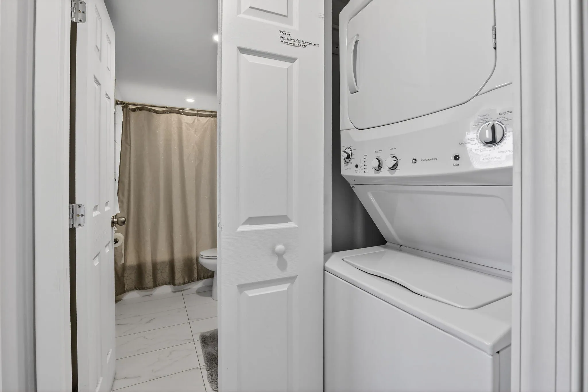 VNEW washer and dryer is thoughtfully positioned in the guest hallway for easy access!
