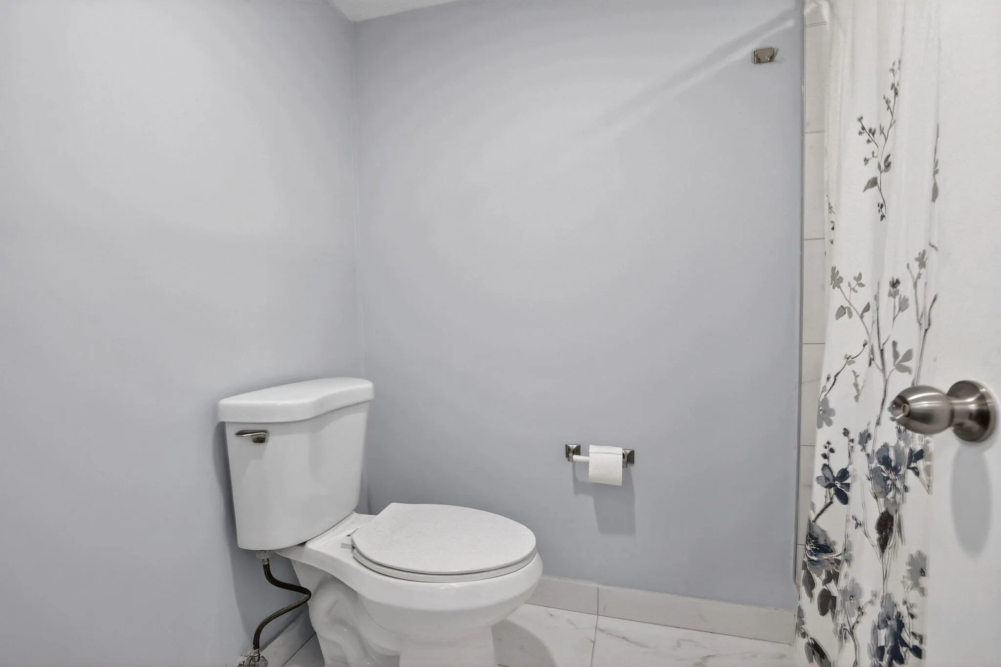 Separate primary water closet with shower offers privacy with clean, modern lines!