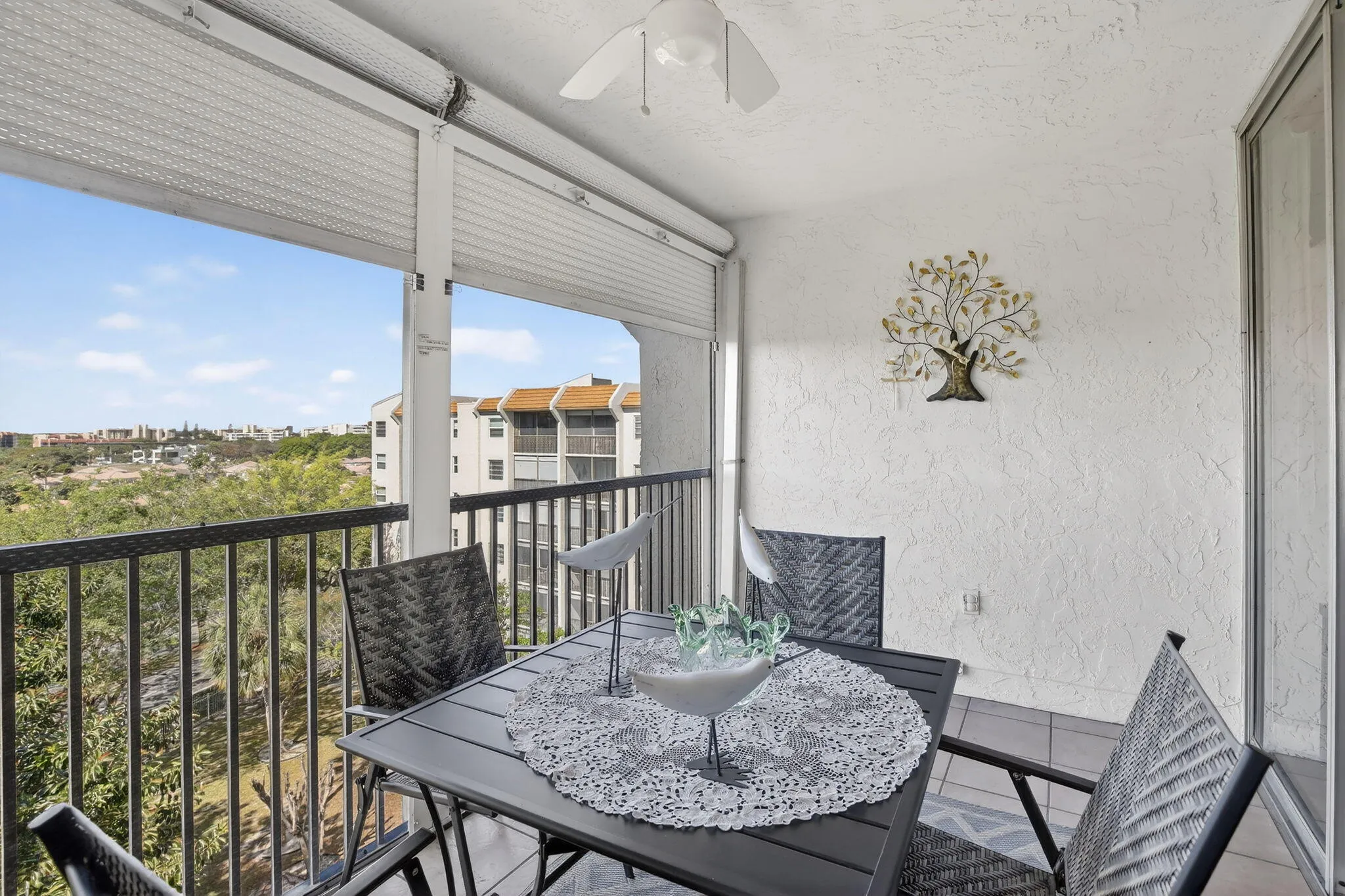 Oversized, screened-in patio is perfect for serving a meal al fresco and enjoying the amazing breeze from the top floor!