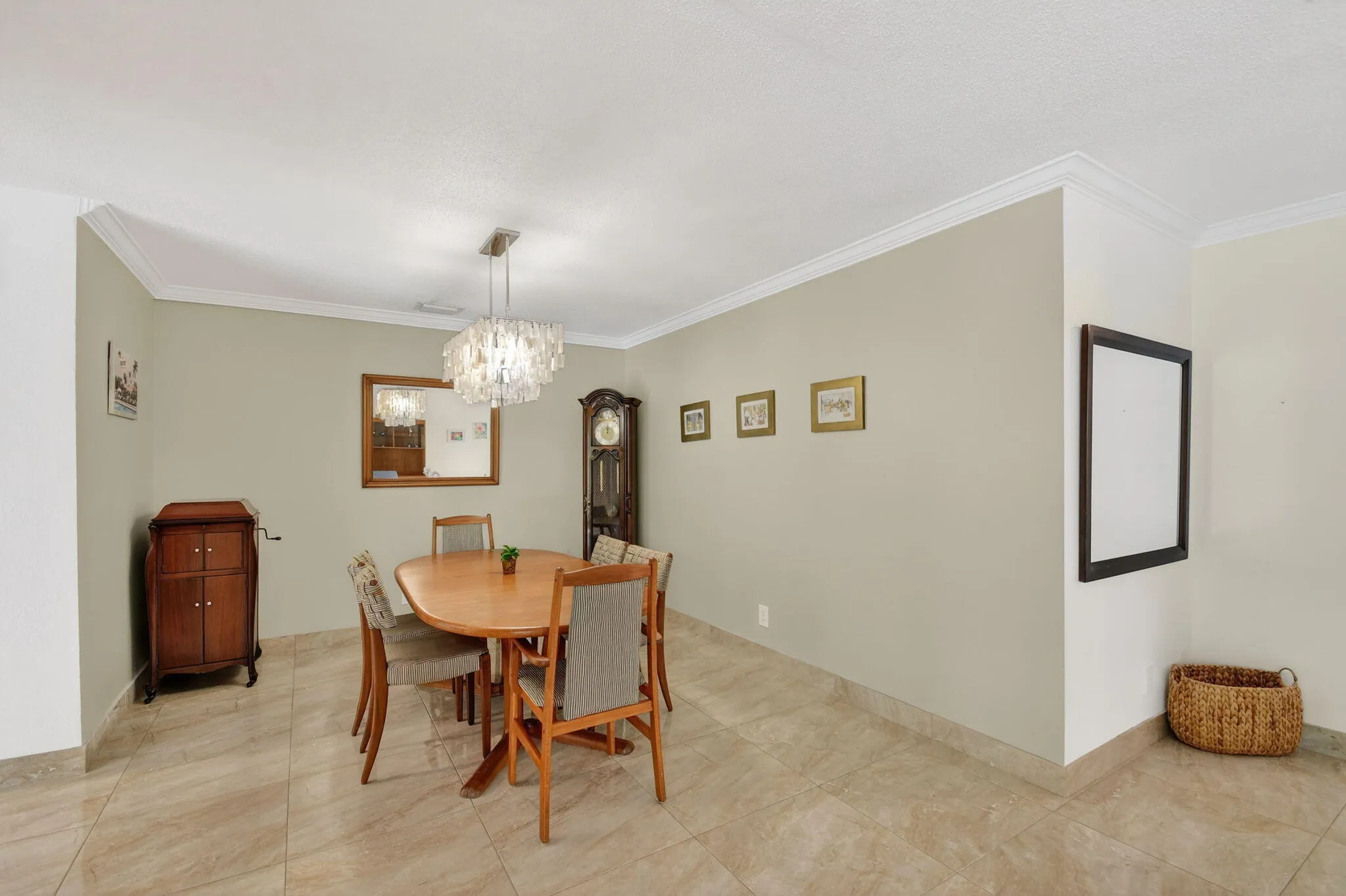 Formal dining area with tile flooring and overhead lighting fixture located adjacent to the main living space.