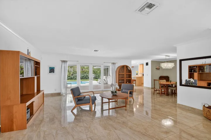Alternate view of the living room showing open layout and connection to adjacent living spaces.