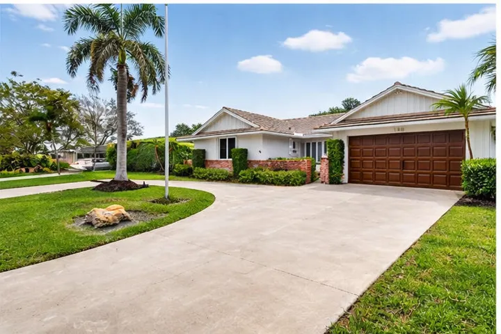 Spacious circular driveway providing easy access to the attached garage with additional guest parking space.