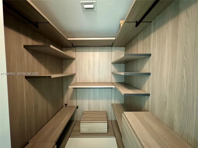 Primary bedroom walk-in closet