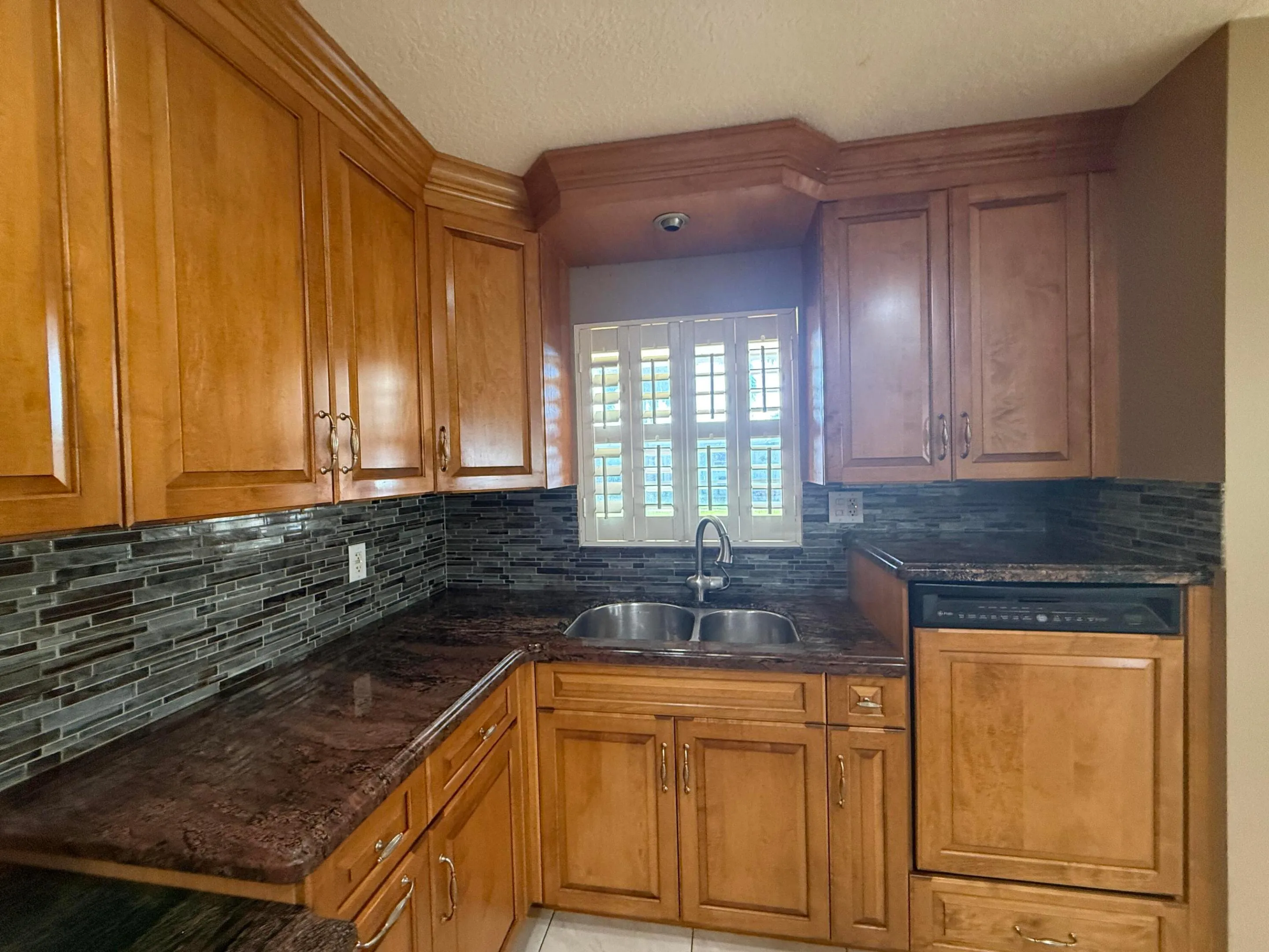 Elevated dishwasher and sink overlooking the window