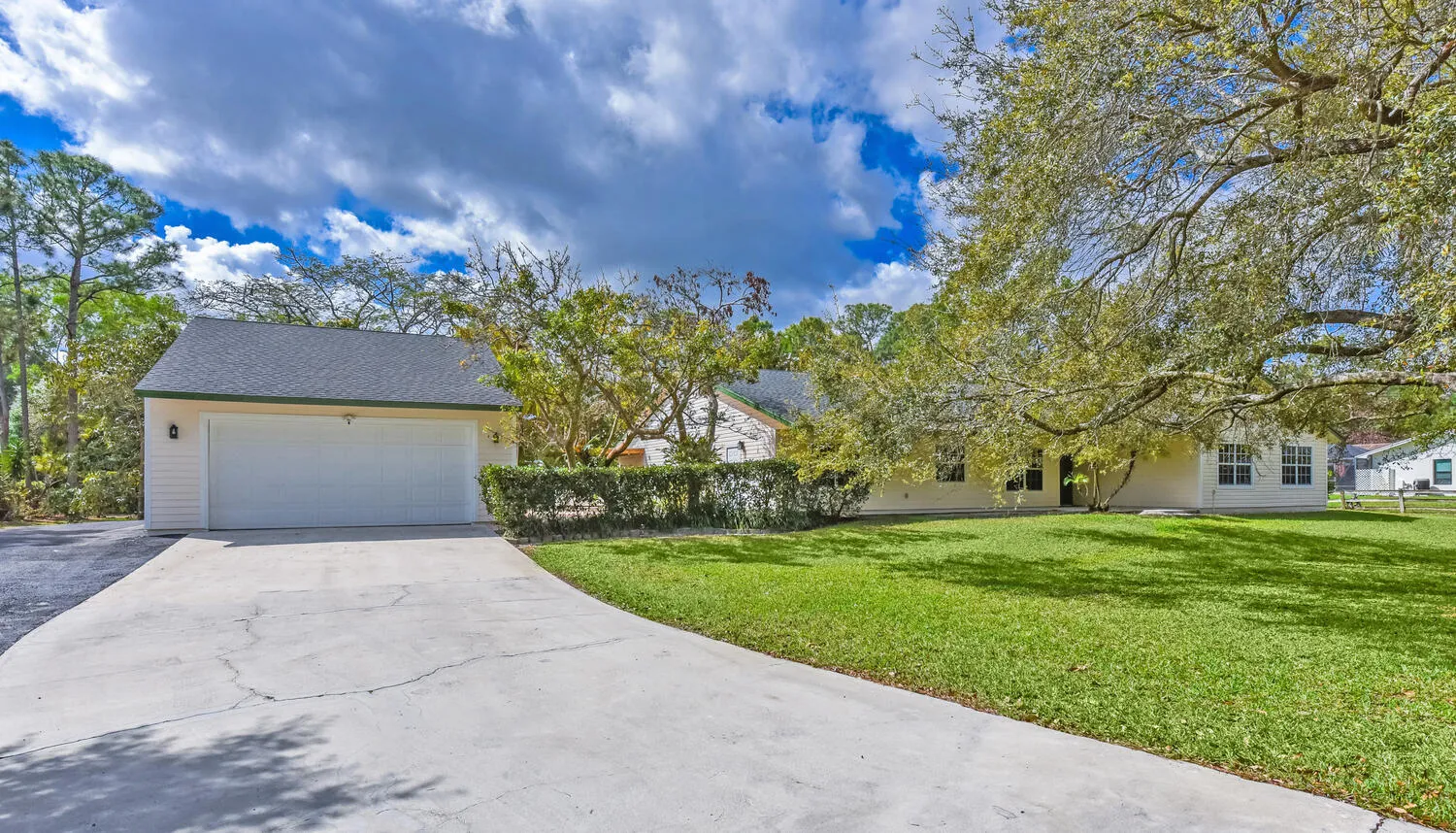 concrete driveway with asphalt RV pad