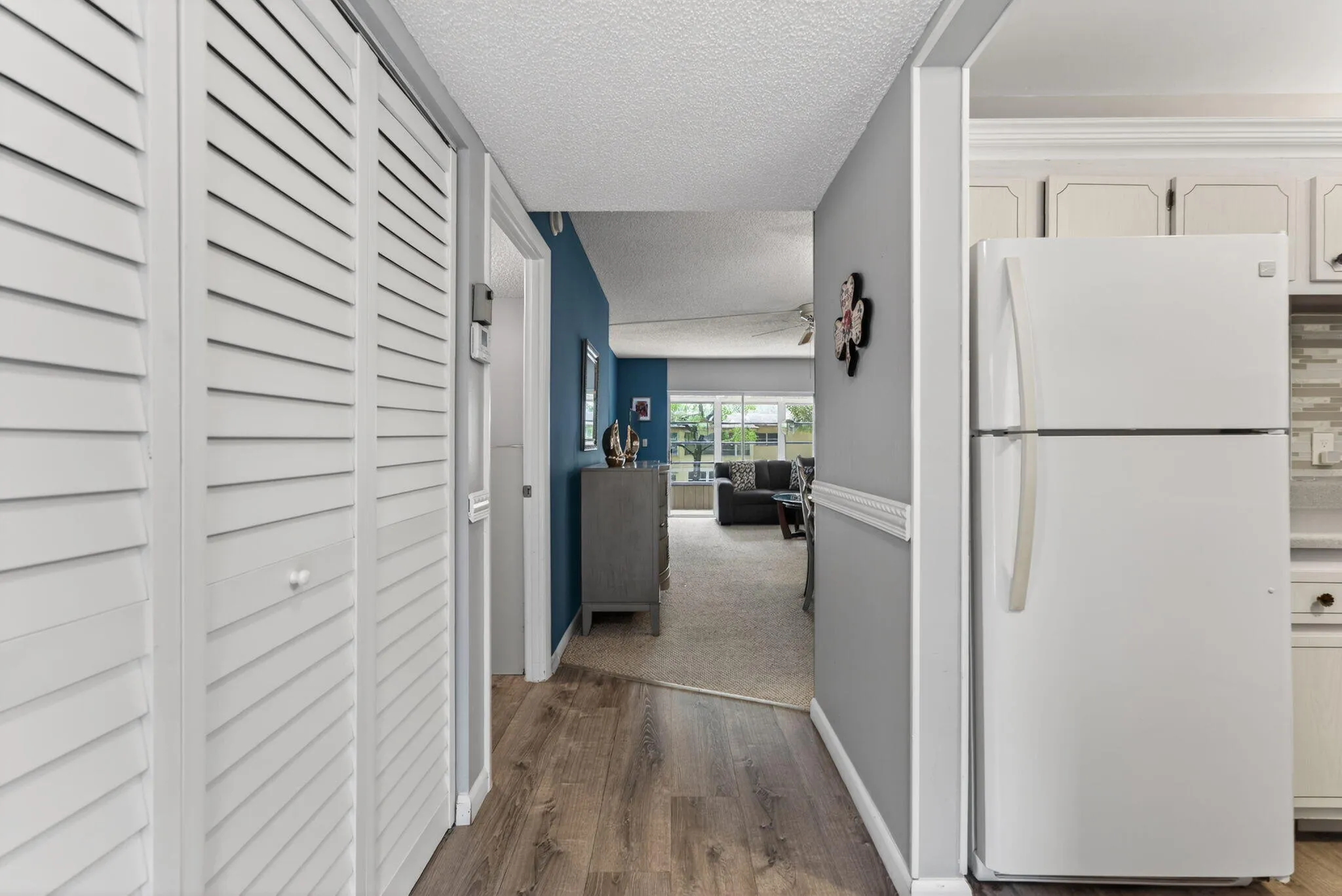 Entry, Kitchen and Foyer to Guest area has Wood tone Floors.