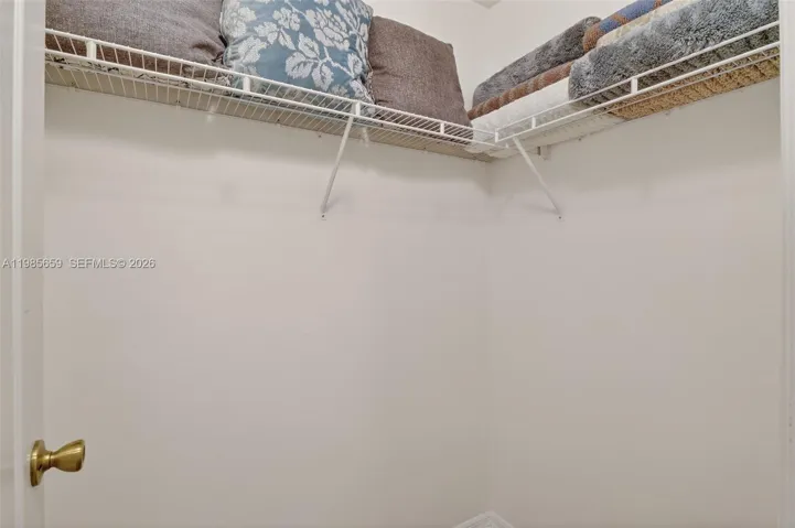 1 of 2 walk-in closets in primary bedroom