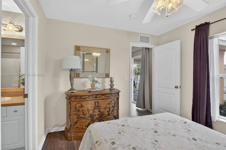2nd guest bedroom waterproof wood-look floors, ceiling fan, tall window