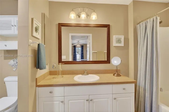 Ensuite with privacy wall for toilet, shower/tub combo, vanity