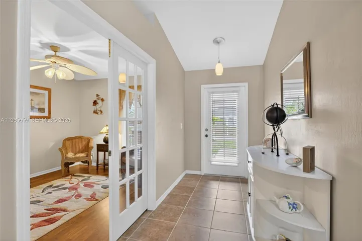 Welcoming foyer w/French doors to den