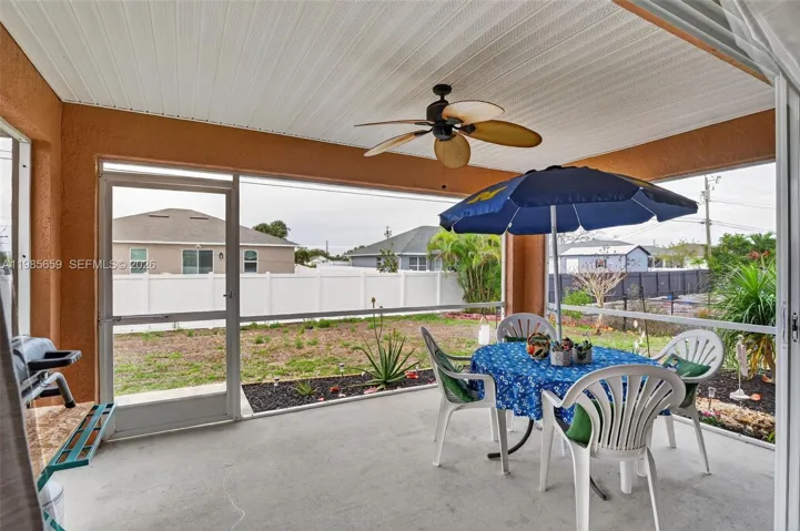 Large patio under roof and new screens and ceiling, with ceiling fan
