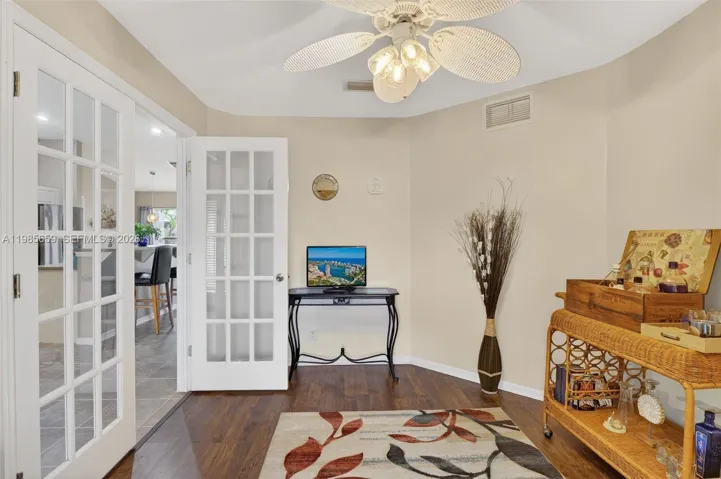 Flex space w/waterproof wood-look floor, ceiling fan, French doors, window