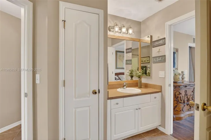 Dual access guest bathroom with linen closet