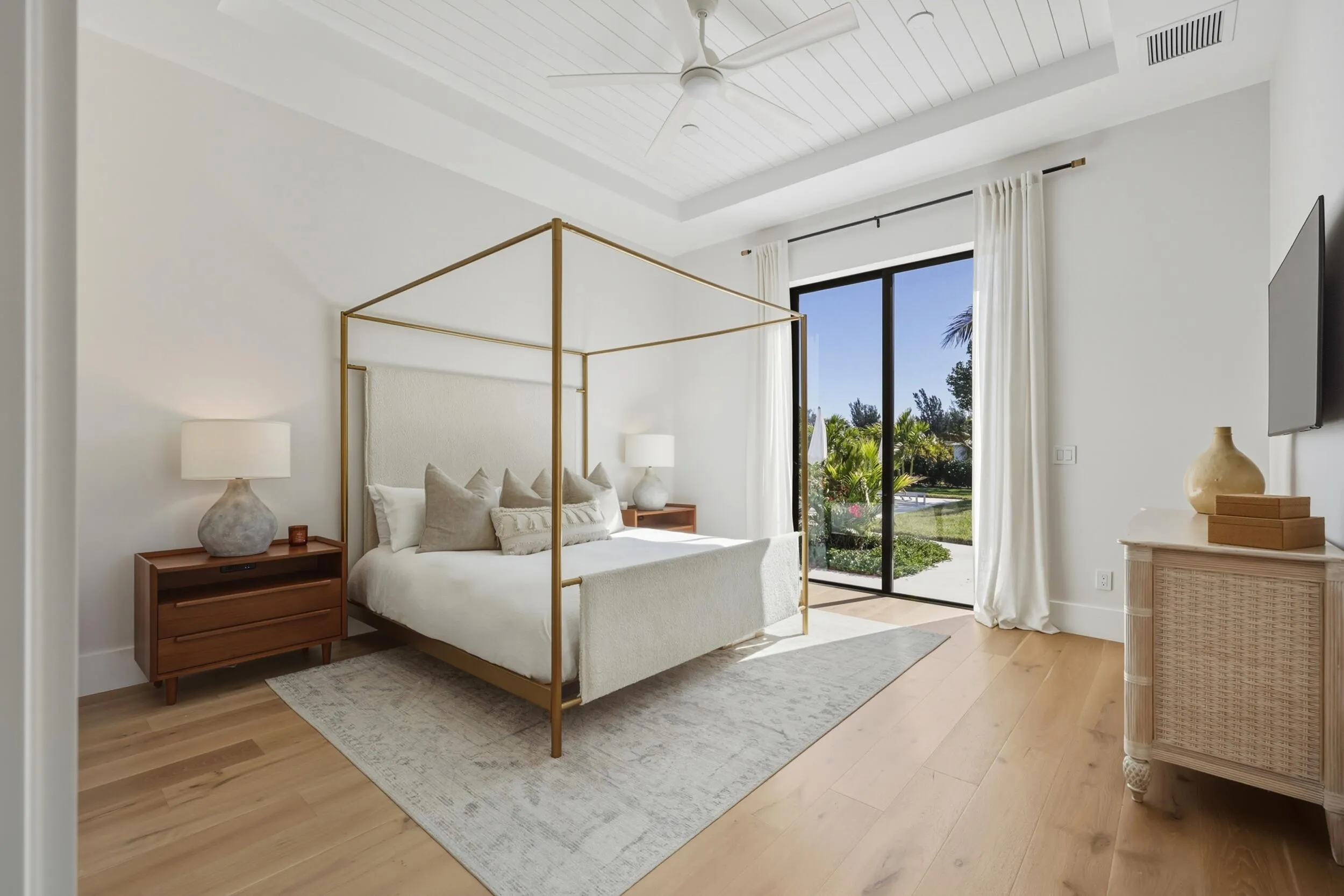 Owner's suite with shiplap tray ceiling, 2 walk in closets & access to backyard
