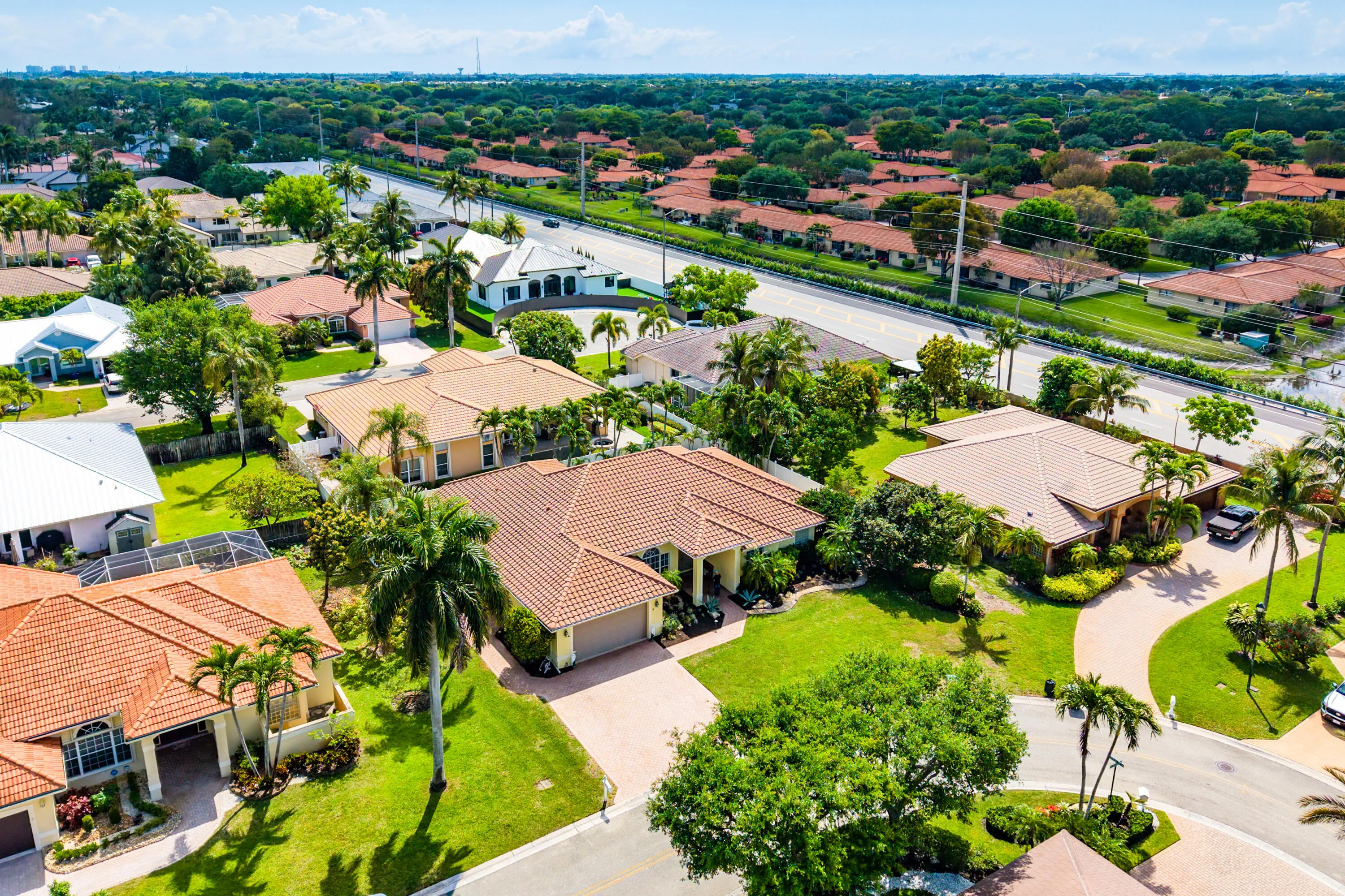Spacious outdoor living area with pool, spa, and covered patio. Luxury Cypress Creek home featuring indoor and outdoor entertaining spaces. Backyard oasis in Cypress Creek with tropical landscaping, pool, spa, and multiple seating areas perfect for Florida living.