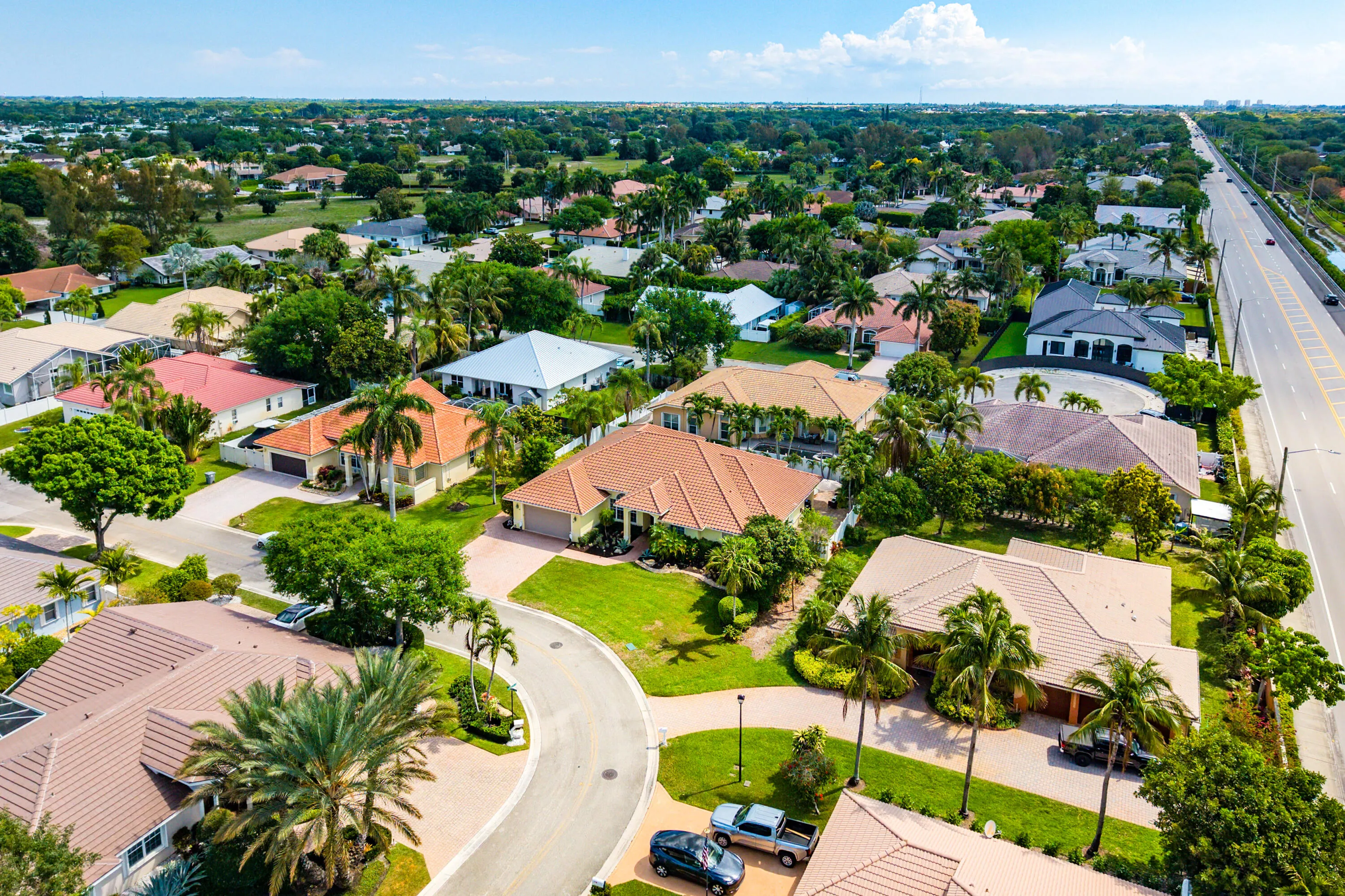 Spacious outdoor living area with pool, spa, and covered patio. Luxury Cypress Creek home featuring indoor and outdoor entertaining spaces. Backyard oasis in Cypress Creek with tropical landscaping, pool, spa, and multiple seating areas perfect for Florida living.