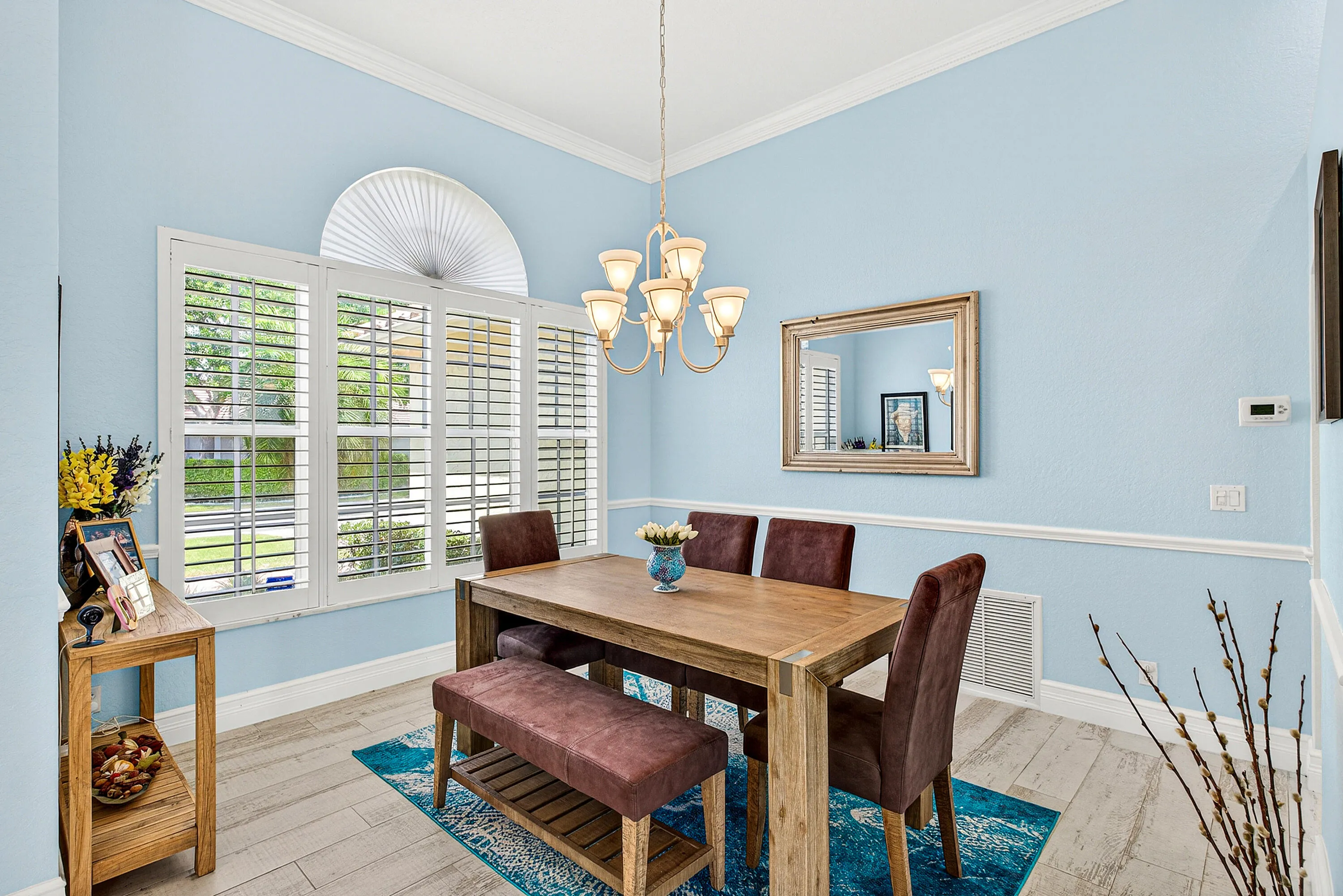Formal dining area ideal for family gatherings and entertaining guests in this luxury Boynton Beach home. Elegant dining space conveniently located near the kitchen and main living areas.