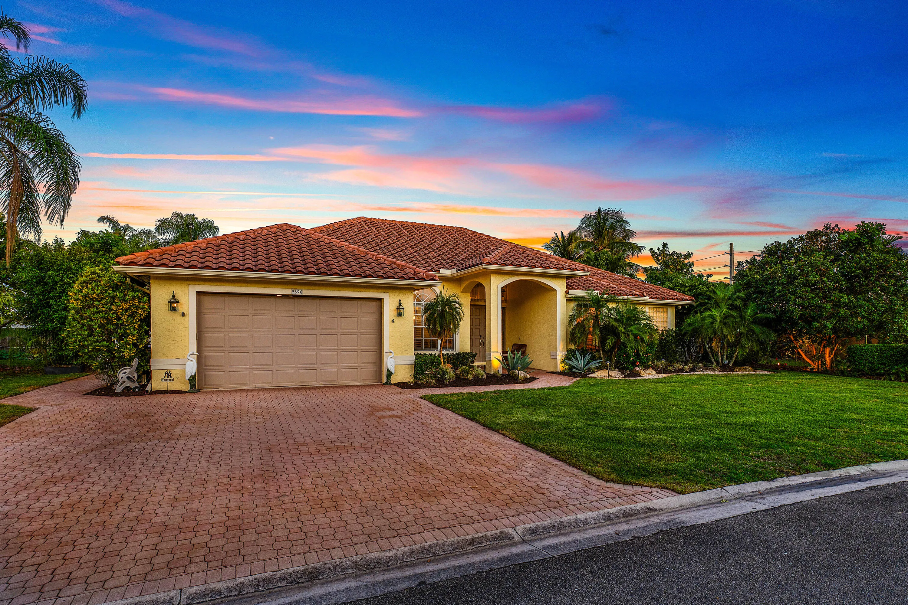 Stunning twilight view of this luxury Cypress Creek pool home featuring 4 bedrooms, 3 bathrooms, and a roof installed in October 2022. Beautiful evening exterior showcasing the resort-style atmosphere and exceptional curb appeal of this Boynton Beach residence.