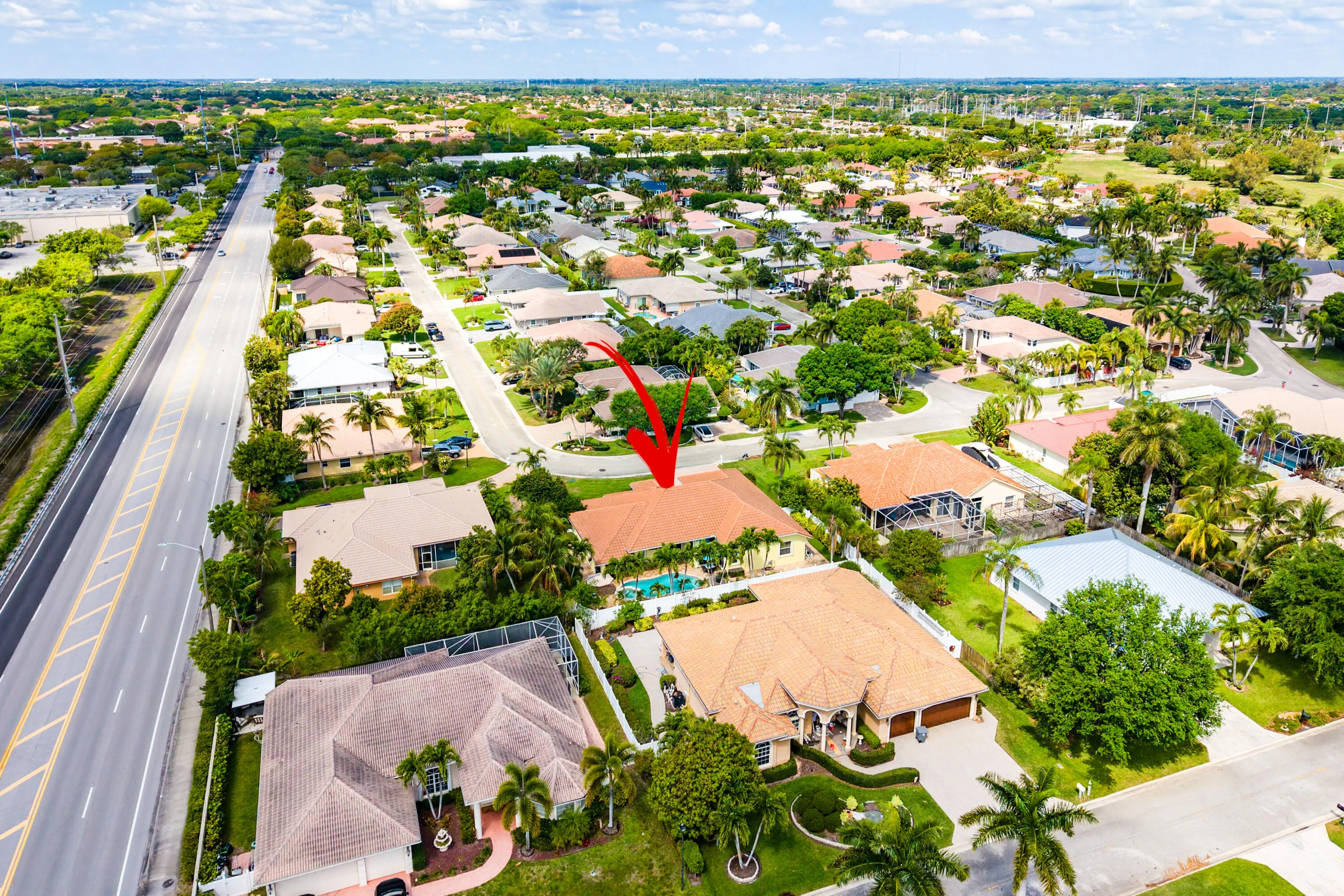 Spacious outdoor living area with pool, spa, and covered patio. Luxury Cypress Creek home featuring indoor and outdoor entertaining spaces. Backyard oasis in Cypress Creek with tropical landscaping, pool, spa, and multiple seating areas perfect for Florida living.