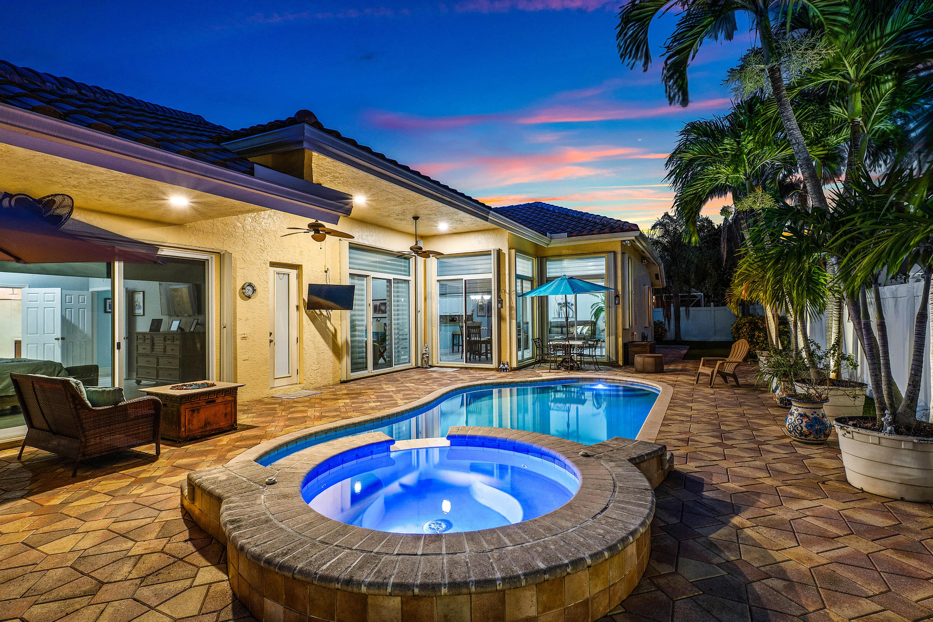 Resort-style pool and spa overlooking the tropical backyard of this luxury Cypress Creek home. Designed for entertaining and enjoying the South Florida lifestyle. Private heated pool and spa surrounded by lush landscaping in this 4 bedroom, 3 bathroom Cypress Creek residence in Boynton Beach.