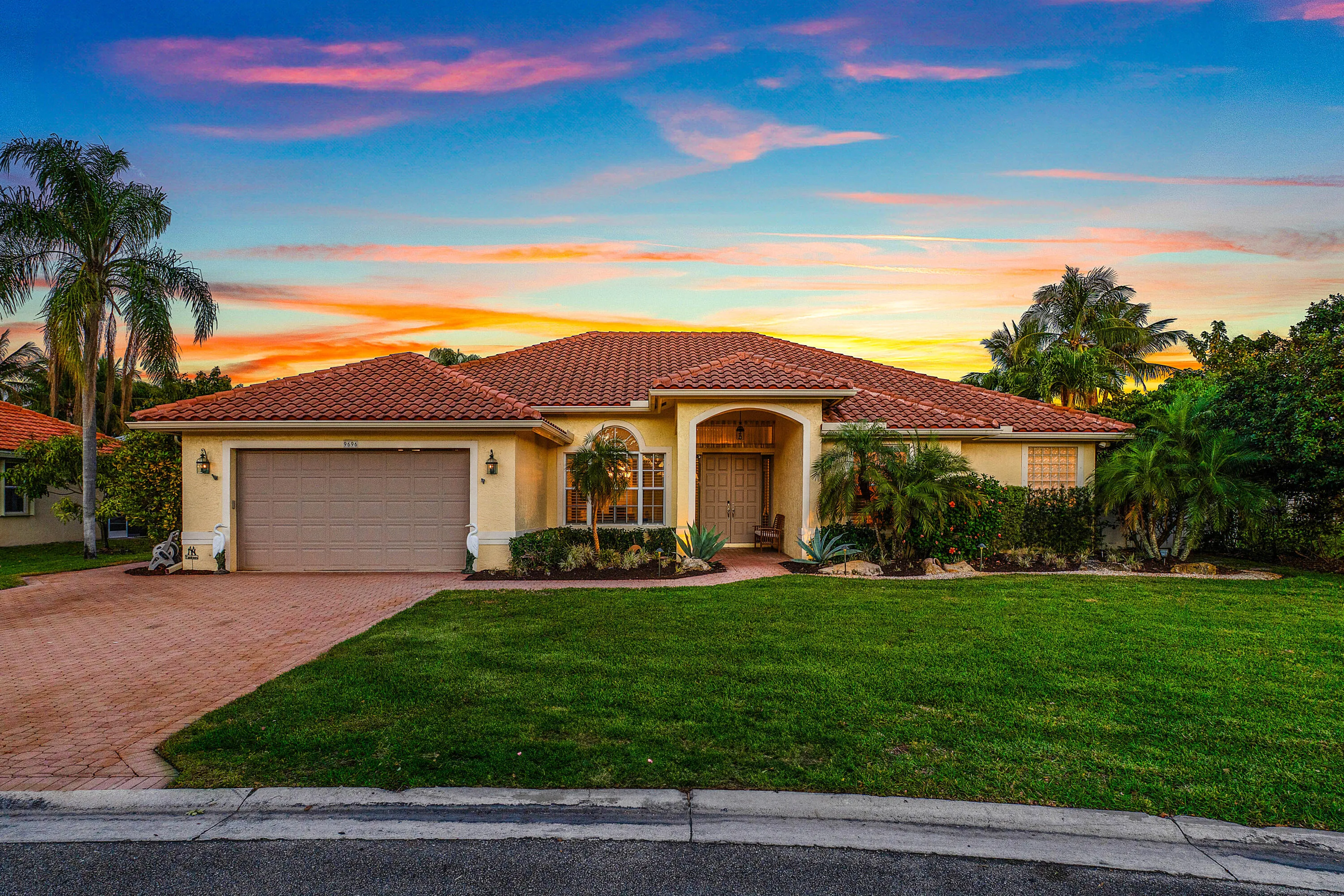 Stunning twilight view of this luxury Cypress Creek pool home featuring 4 bedrooms, 3 bathrooms, and a roof installed in October 2022. Beautiful evening exterior showcasing the resort-style atmosphere and exceptional curb appeal of this Boynton Beach residence.