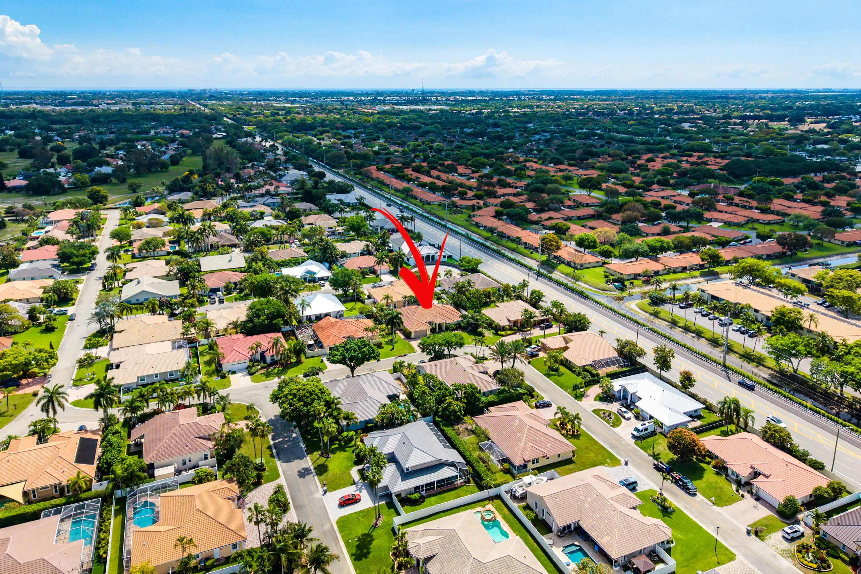Spacious outdoor living area with pool, spa, and covered patio. Luxury Cypress Creek home featuring indoor and outdoor entertaining spaces. Backyard oasis in Cypress Creek with tropical landscaping, pool, spa, and multiple seating areas perfect for Florida living.