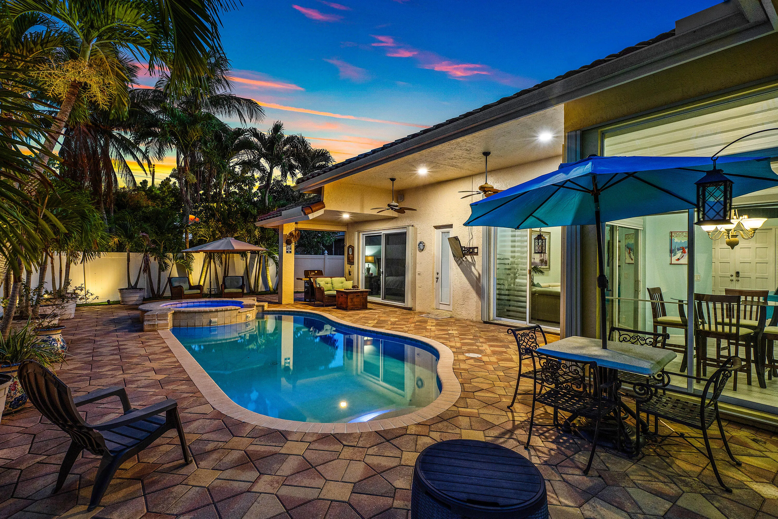 Resort-style pool and spa overlooking the tropical backyard of this luxury Cypress Creek home. Designed for entertaining and enjoying the South Florida lifestyle. Private heated pool and spa surrounded by lush landscaping in this 4 bedroom, 3 bathroom Cypress Creek residence in Boynton Beach.