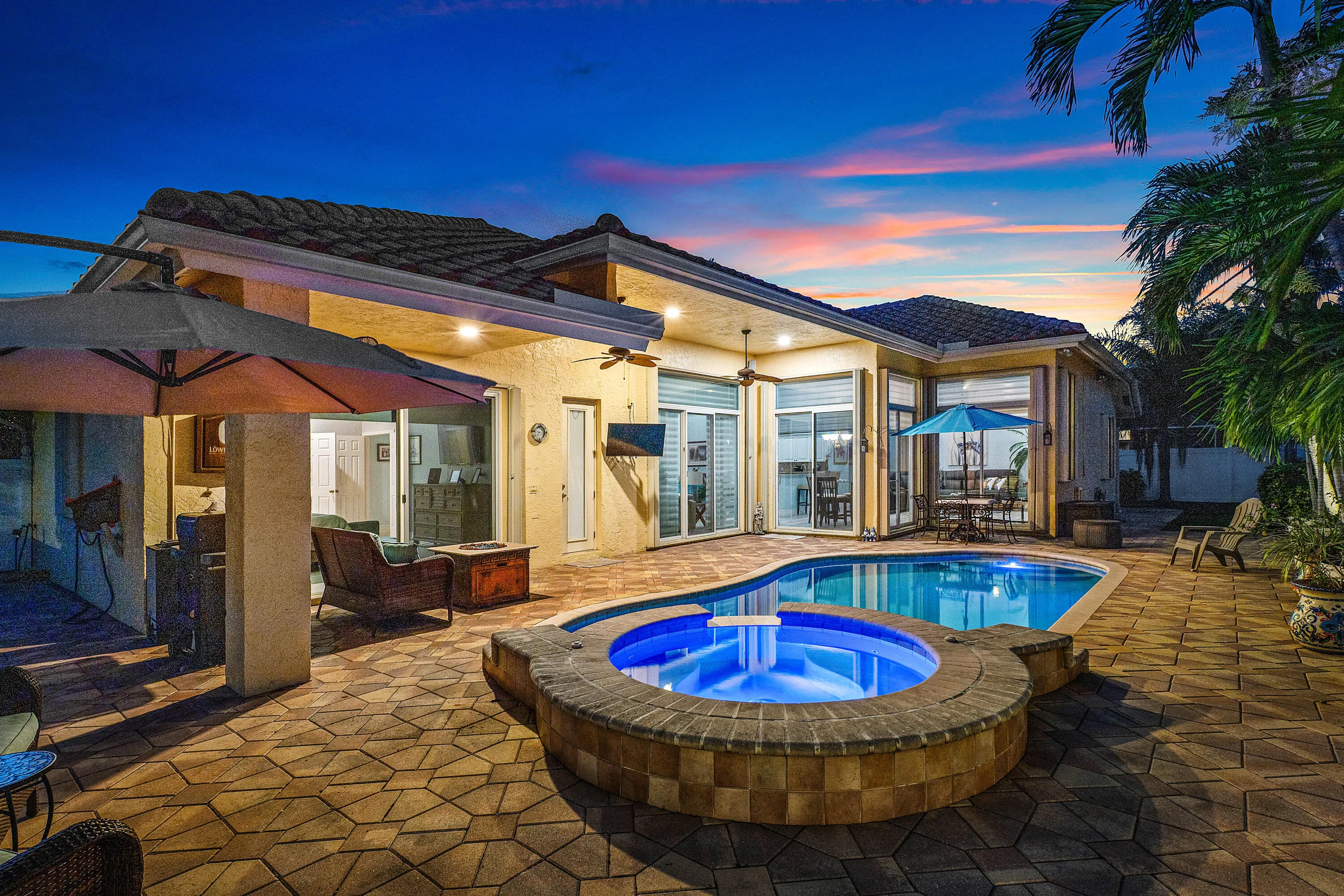 Resort-style pool and spa overlooking the tropical backyard of this luxury Cypress Creek home. Designed for entertaining and enjoying the South Florida lifestyle. Private heated pool and spa surrounded by lush landscaping in this 4 bedroom, 3 bathroom Cypress Creek residence in Boynton Beach.