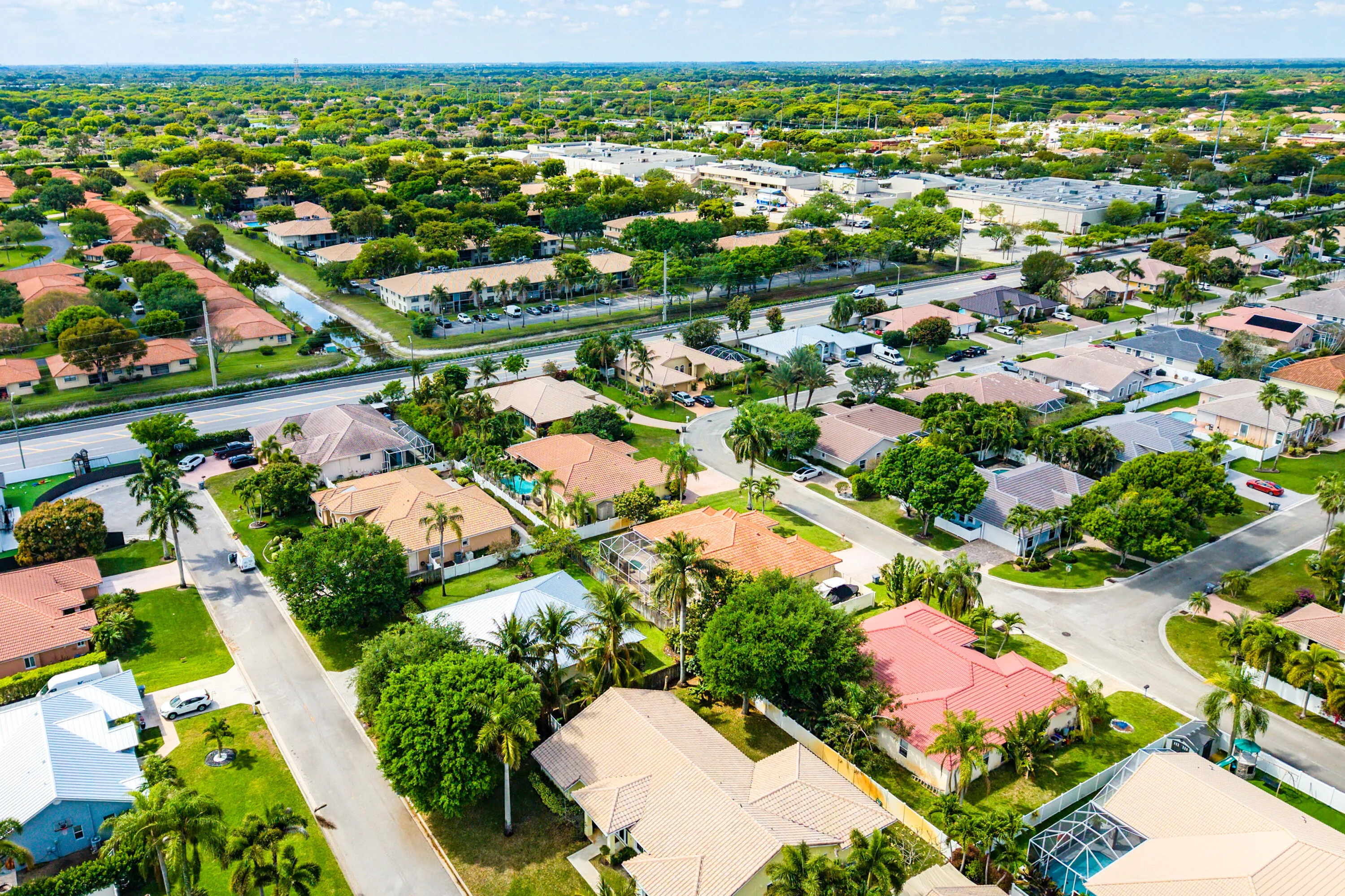 Spacious outdoor living area with pool, spa, and covered patio. Luxury Cypress Creek home featuring indoor and outdoor entertaining spaces. Backyard oasis in Cypress Creek with tropical landscaping, pool, spa, and multiple seating areas perfect for Florida living.