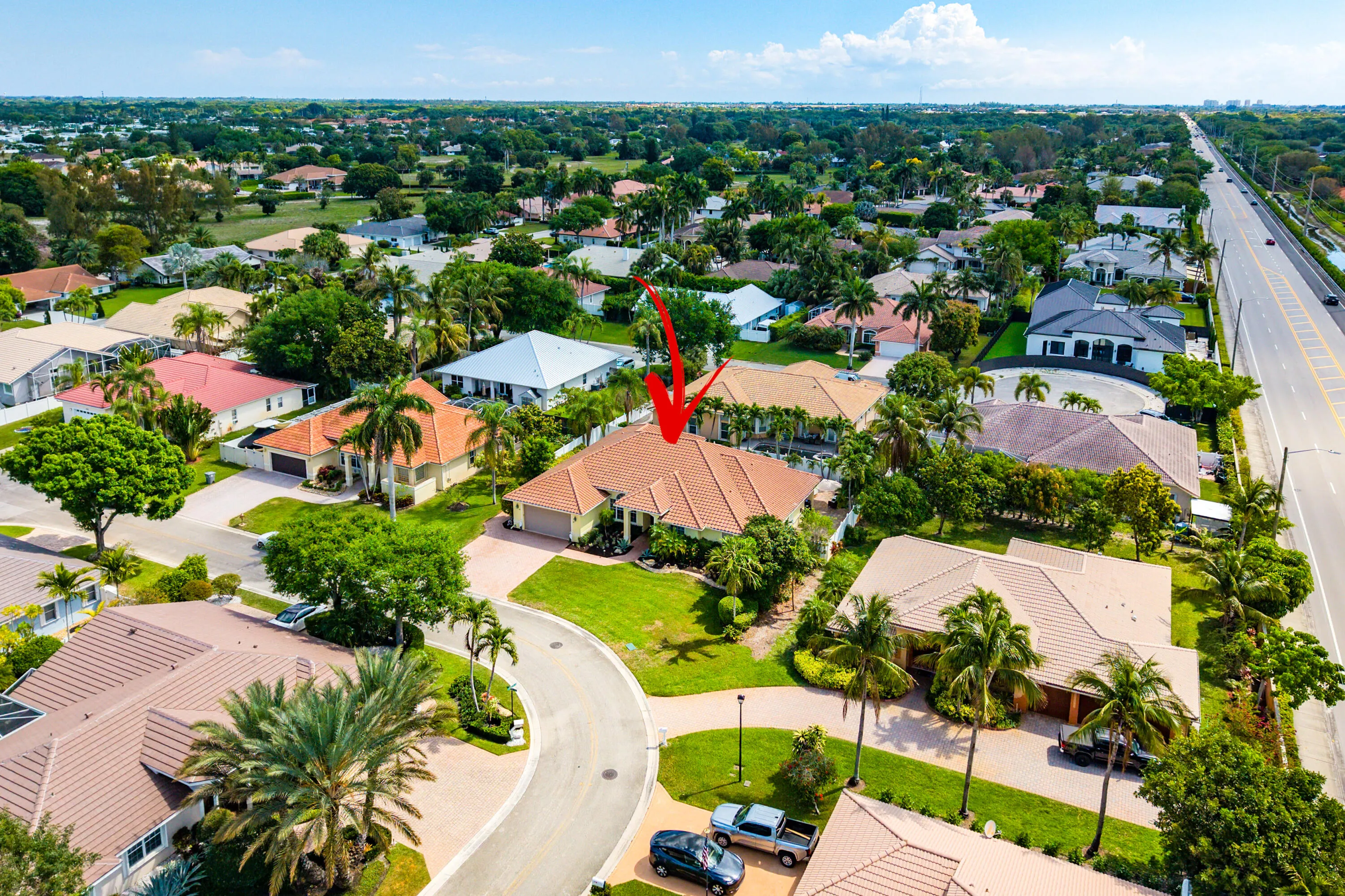 Spacious outdoor living area with pool, spa, and covered patio. Luxury Cypress Creek home featuring indoor and outdoor entertaining spaces. Backyard oasis in Cypress Creek with tropical landscaping, pool, spa, and multiple seating areas perfect for Florida living.