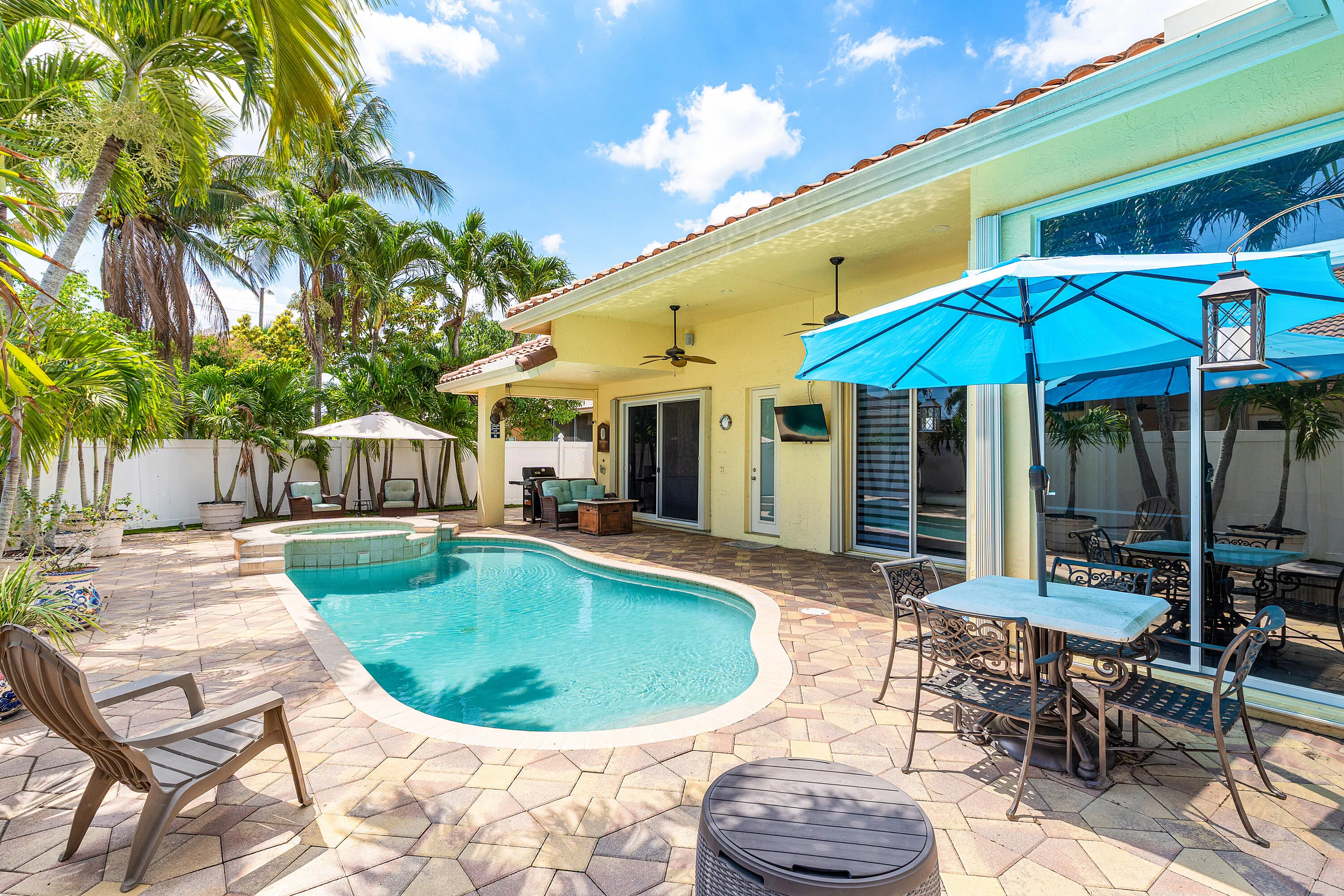 Resort-style pool and spa overlooking the tropical backyard of this luxury Cypress Creek home. Designed for entertaining and enjoying the South Florida lifestyle. Private heated pool and spa surrounded by lush landscaping in this 4 bedroom, 3 bathroom Cypress Creek residence in Boynton Beach.