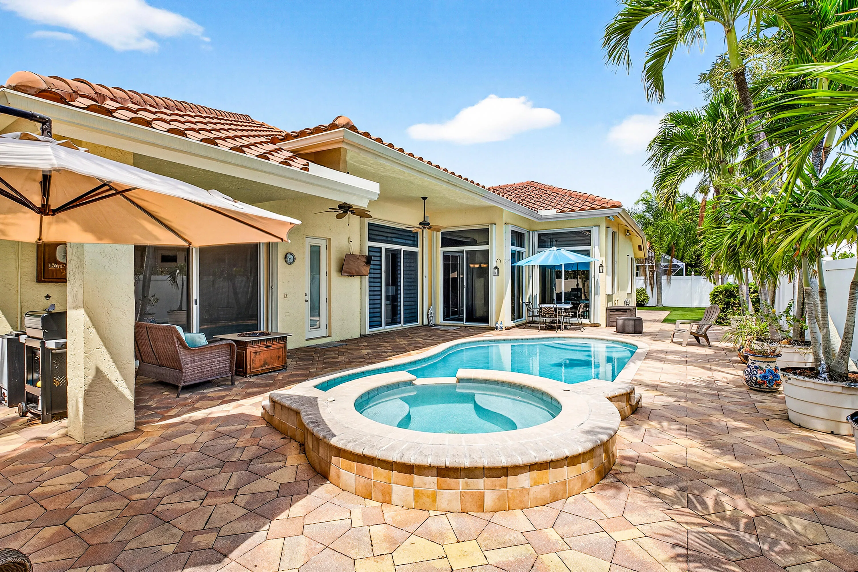 Resort-style pool and spa overlooking the tropical backyard of this luxury Cypress Creek home. Designed for entertaining and enjoying the South Florida lifestyle. Private heated pool and spa surrounded by lush landscaping in this 4 bedroom, 3 bathroom Cypress Creek residence in Boynton Beach.