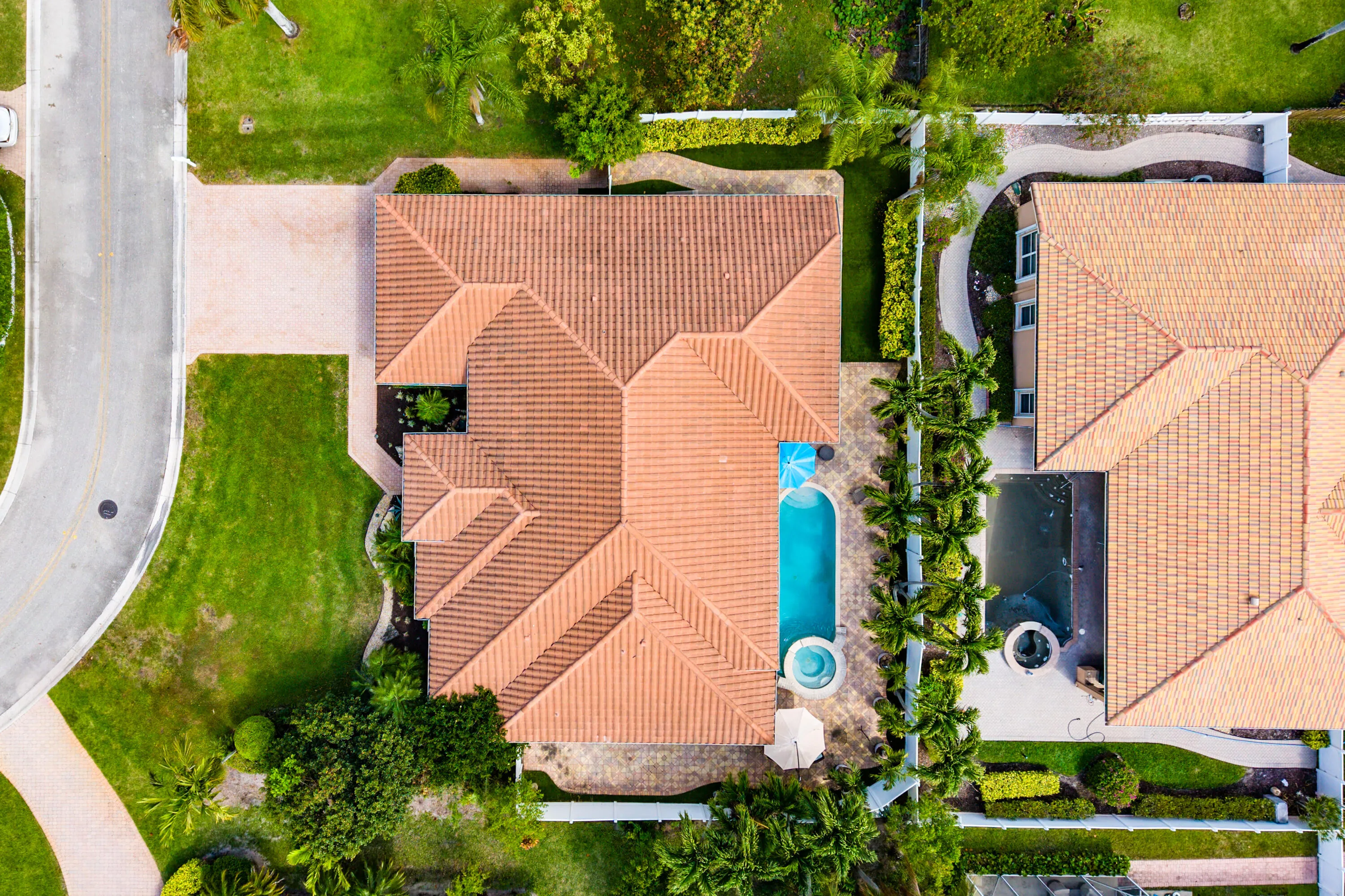 Spacious outdoor living area with pool, spa, and covered patio. Luxury Cypress Creek home featuring indoor and outdoor entertaining spaces. Backyard oasis in Cypress Creek with tropical landscaping, pool, spa, and multiple seating areas perfect for Florida living.