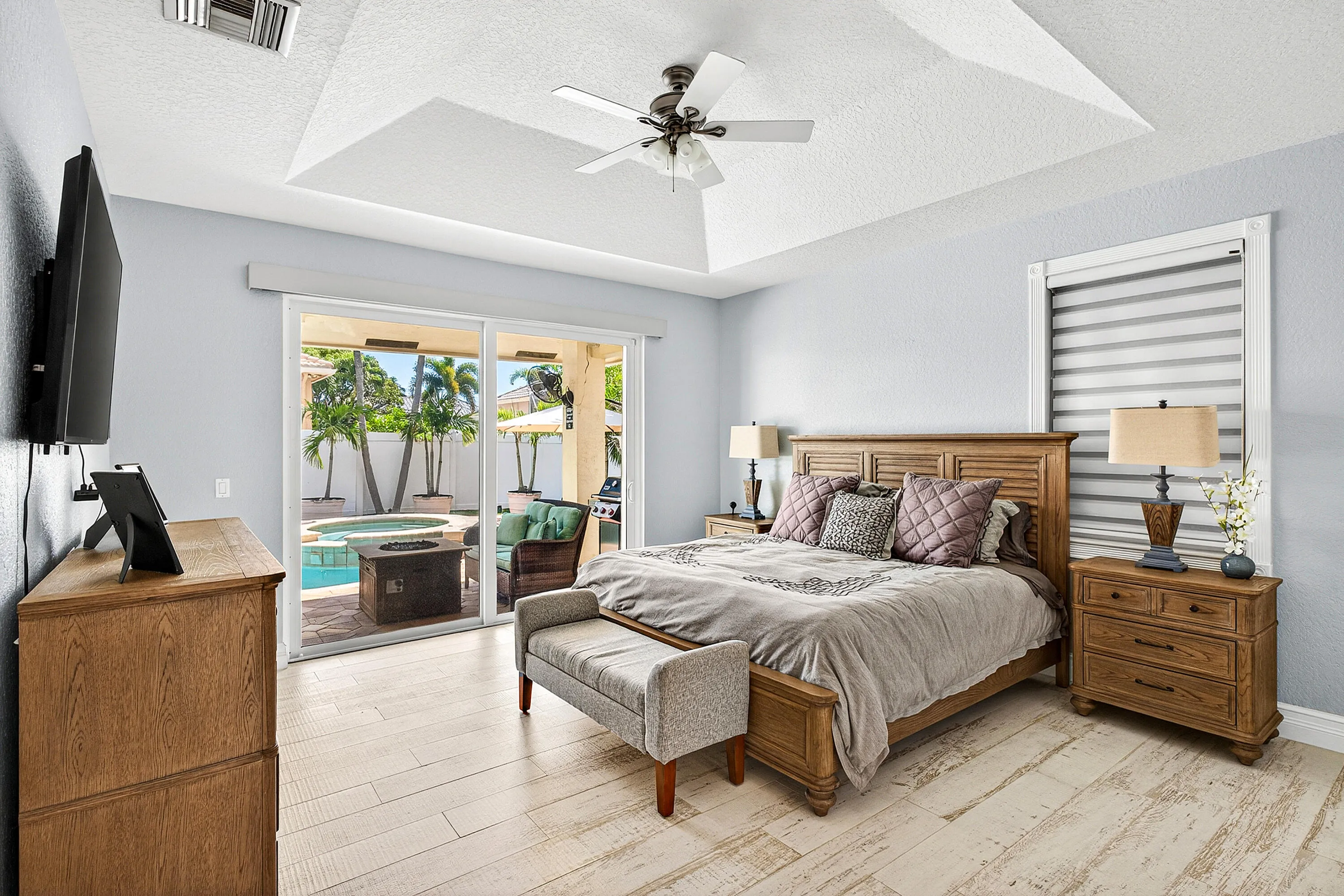 Spacious primary suite featuring private backyard views and generous room for relaxation. Luxury primary bedroom retreat offering comfort, privacy, and access to the outdoor living areas.