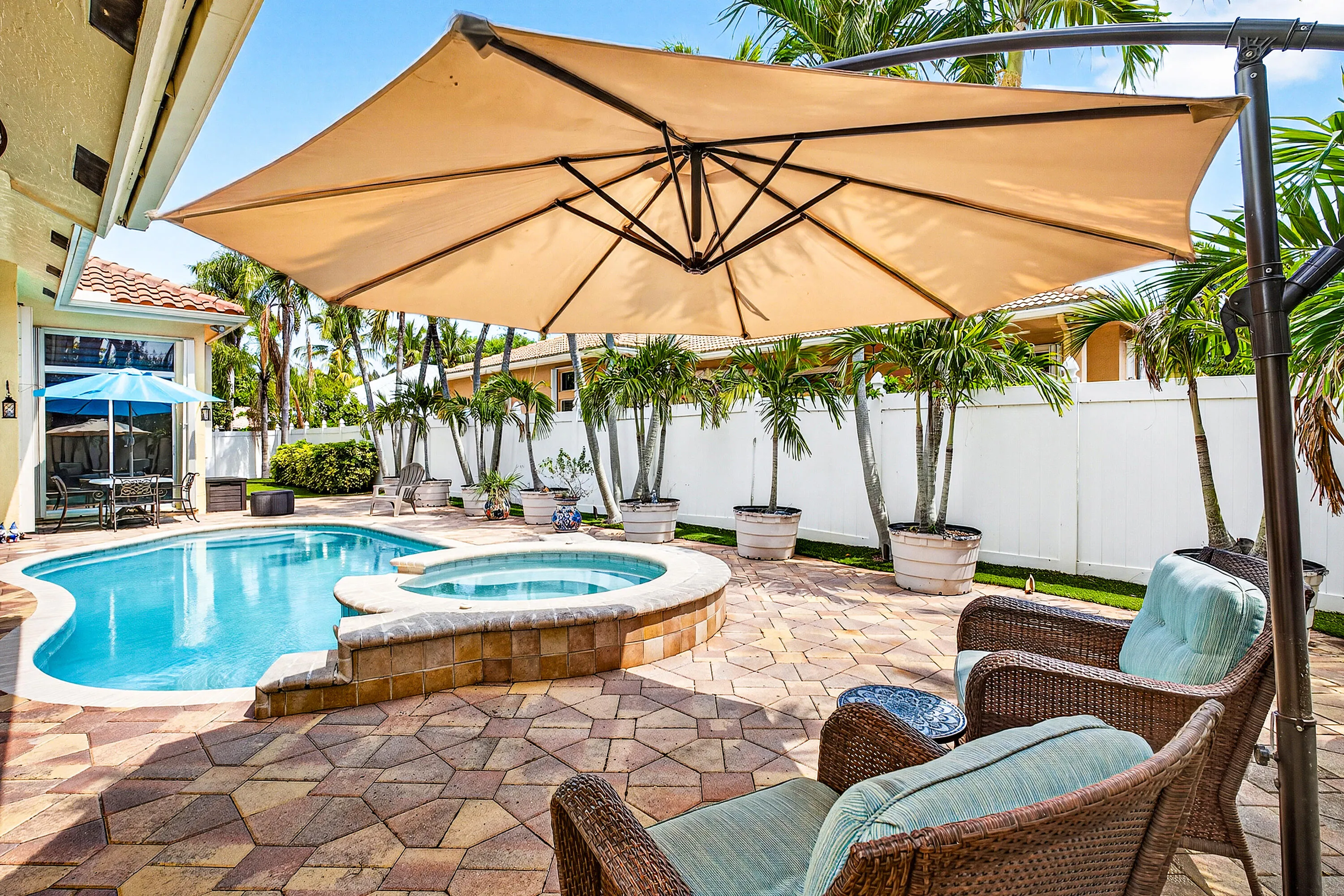 Resort-style pool and spa overlooking the tropical backyard of this luxury Cypress Creek home. Designed for entertaining and enjoying the South Florida lifestyle. Private heated pool and spa surrounded by lush landscaping in this 4 bedroom, 3 bathroom Cypress Creek residence in Boynton Beach.