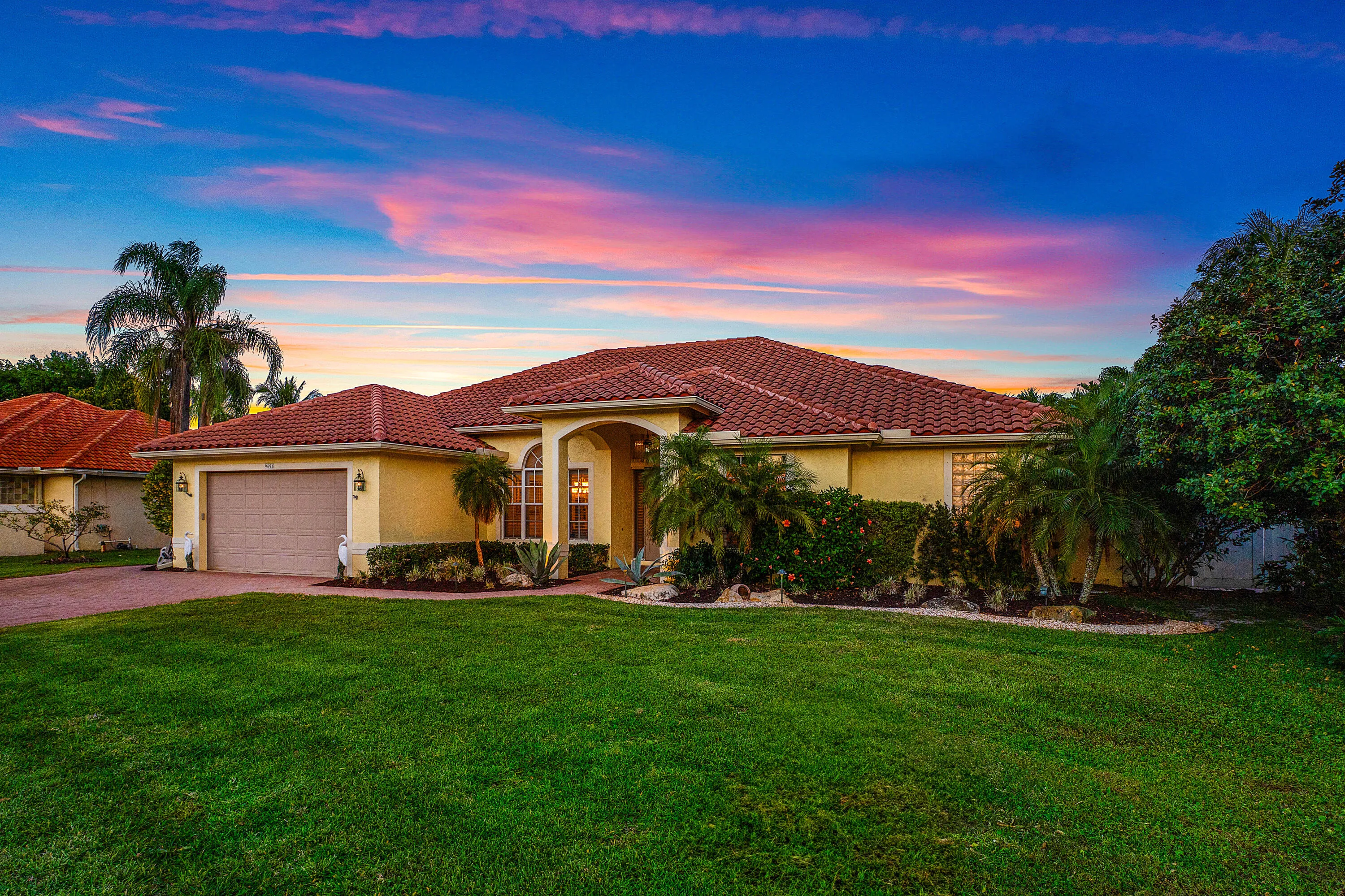 Stunning twilight view of this luxury Cypress Creek pool home featuring 4 bedrooms, 3 bathrooms, and a roof installed in October 2022. Beautiful evening exterior showcasing the resort-style atmosphere and exceptional curb appeal of this Boynton Beach residence.